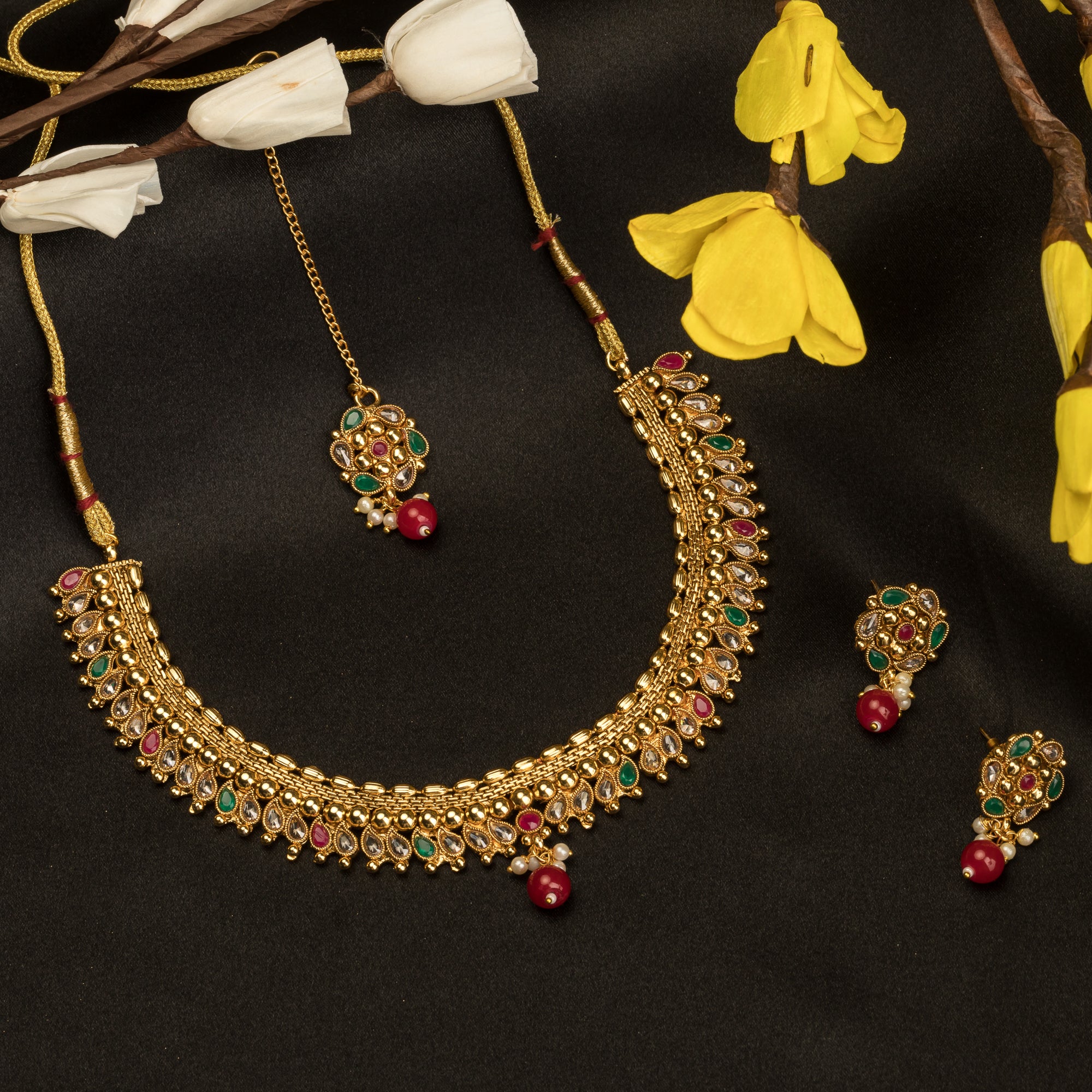 Gold-tone necklace with Kundan and Maang Tikka offers a regal and elegant party statement.