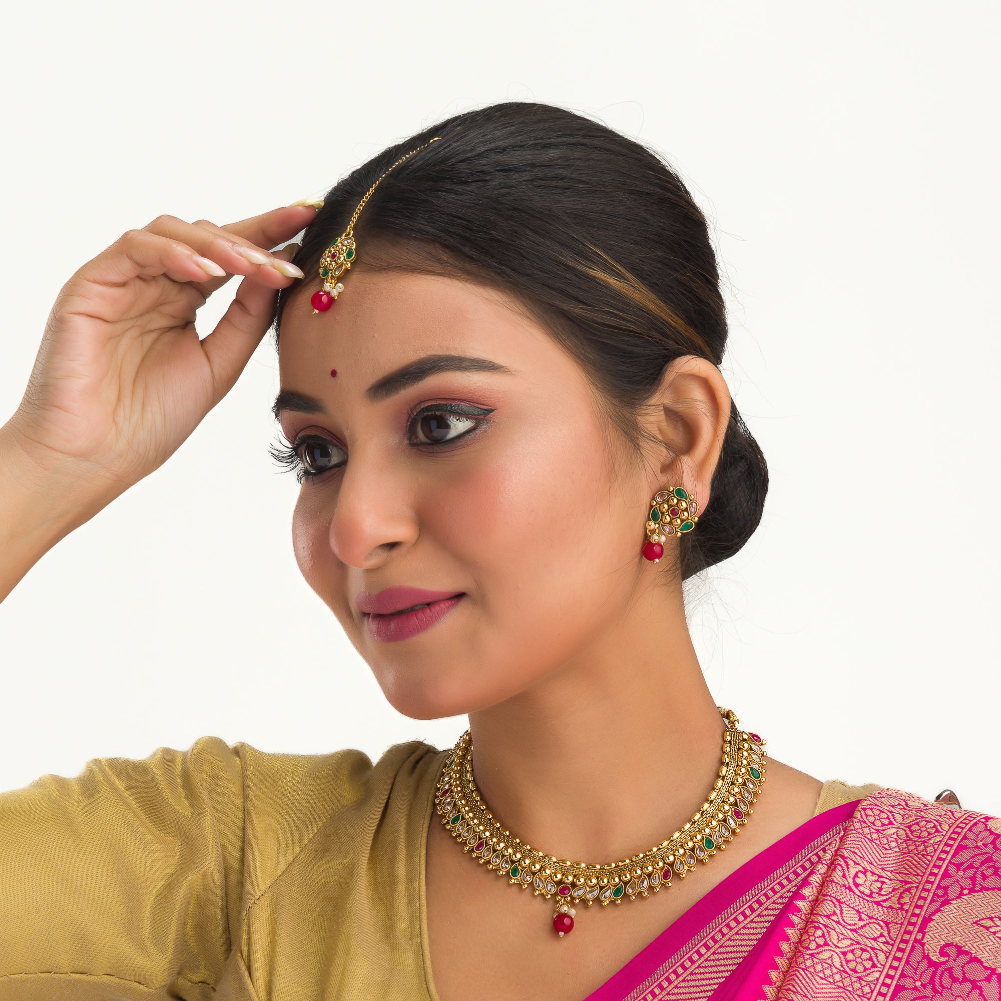 Gold-tone necklace with Kundan and Maang Tikka offers a regal and elegant party statement.