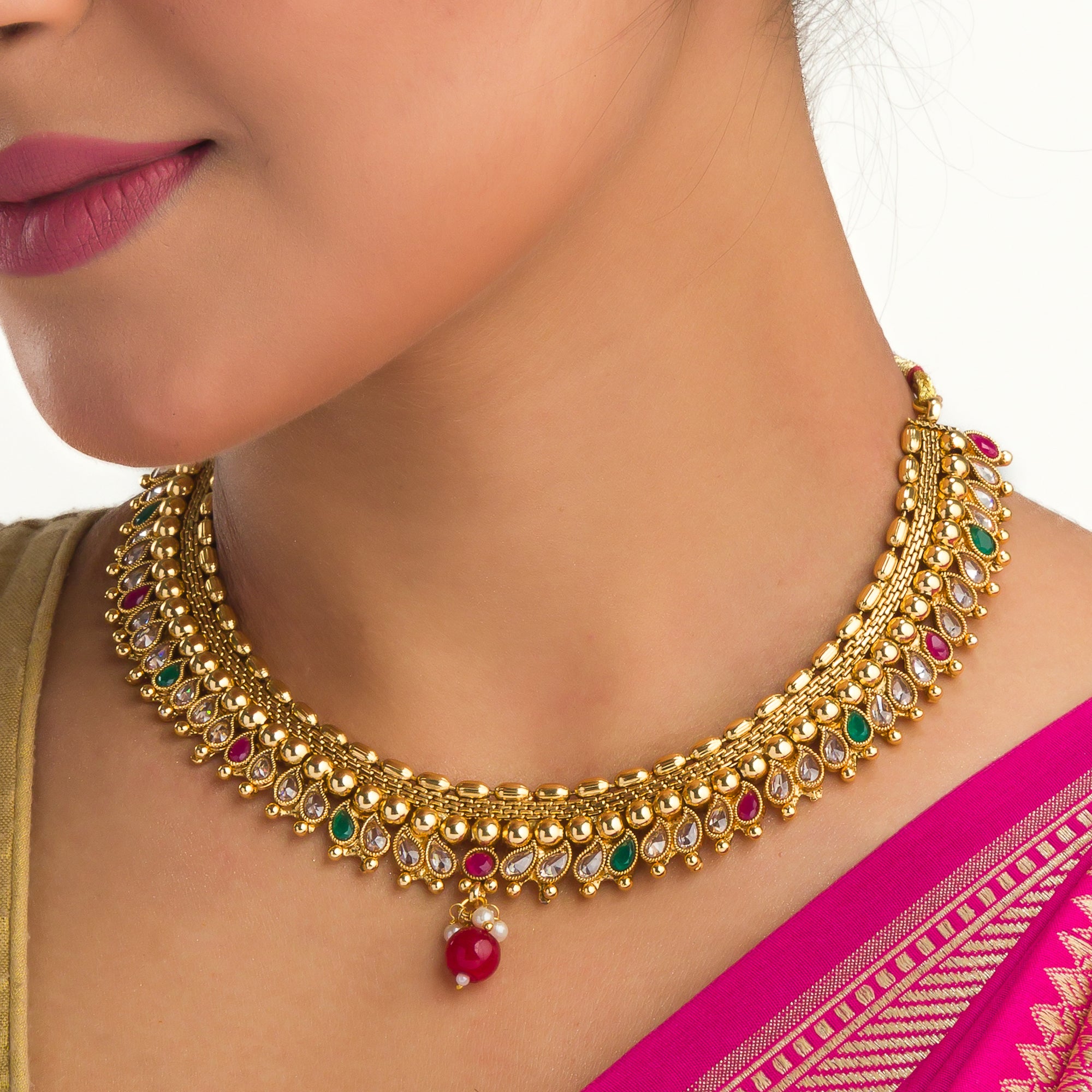 Gold-tone necklace with Kundan and Maang Tikka offers a regal and elegant party statement.