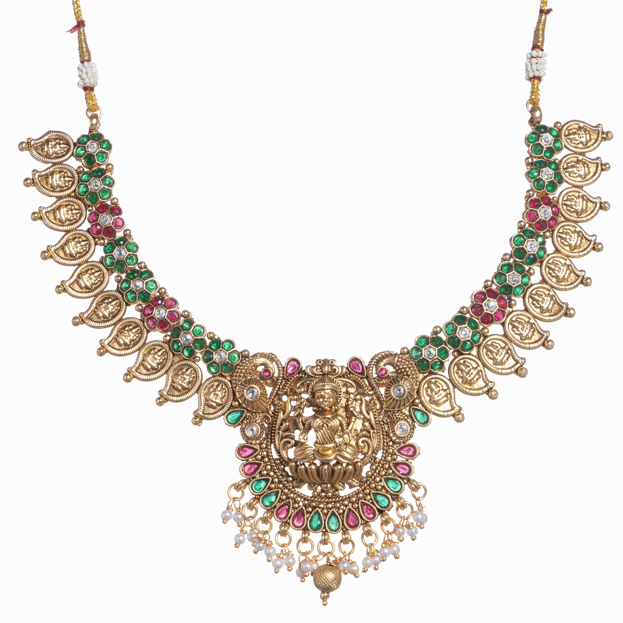 Intricate temple jewelry in red, gold, and green brings classic elegance to festival occasions.