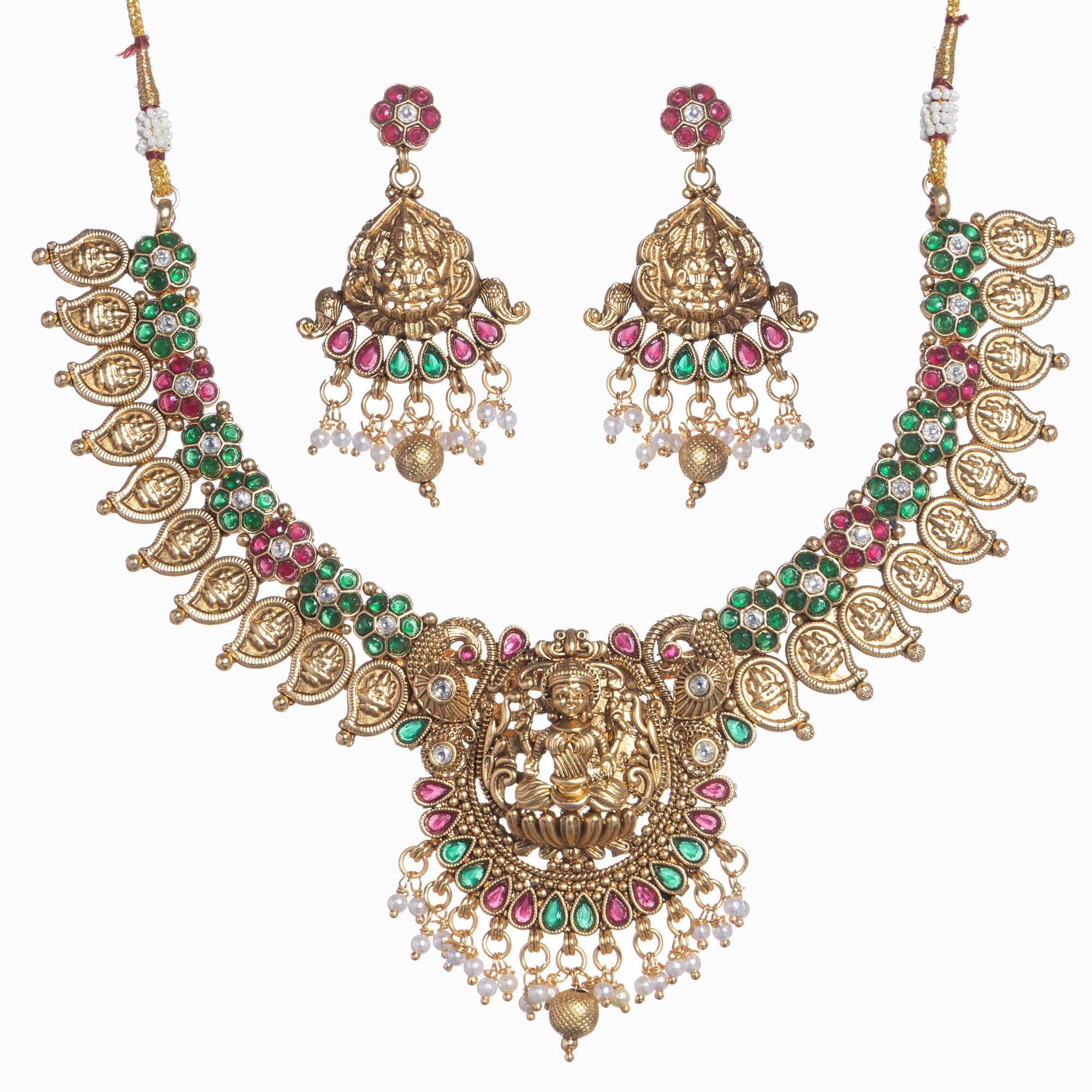 Intricate temple jewelry in red, gold, and green brings classic elegance to festival occasions.
