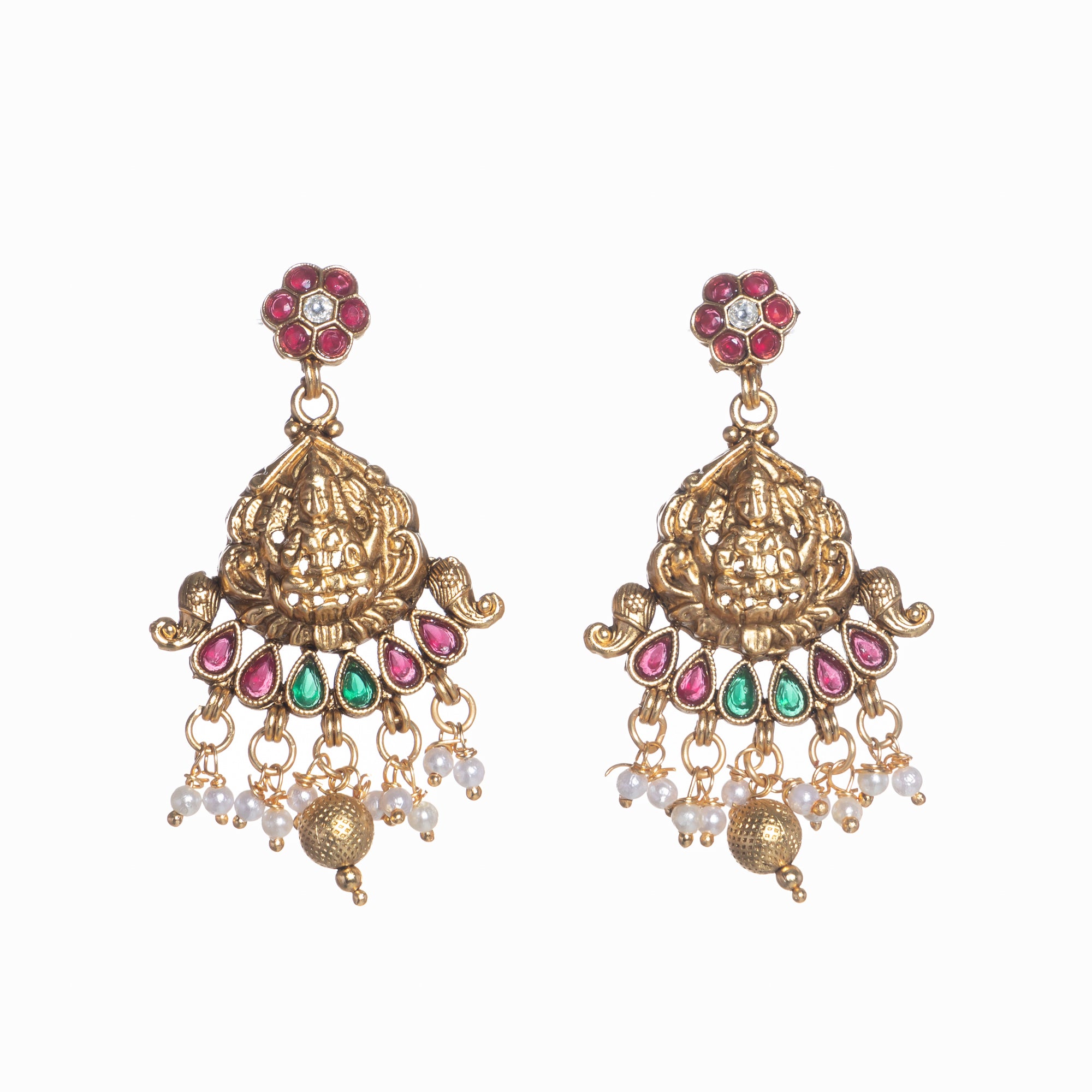 Intricate temple jewelry in red, gold, and green brings classic elegance to festival occasions.