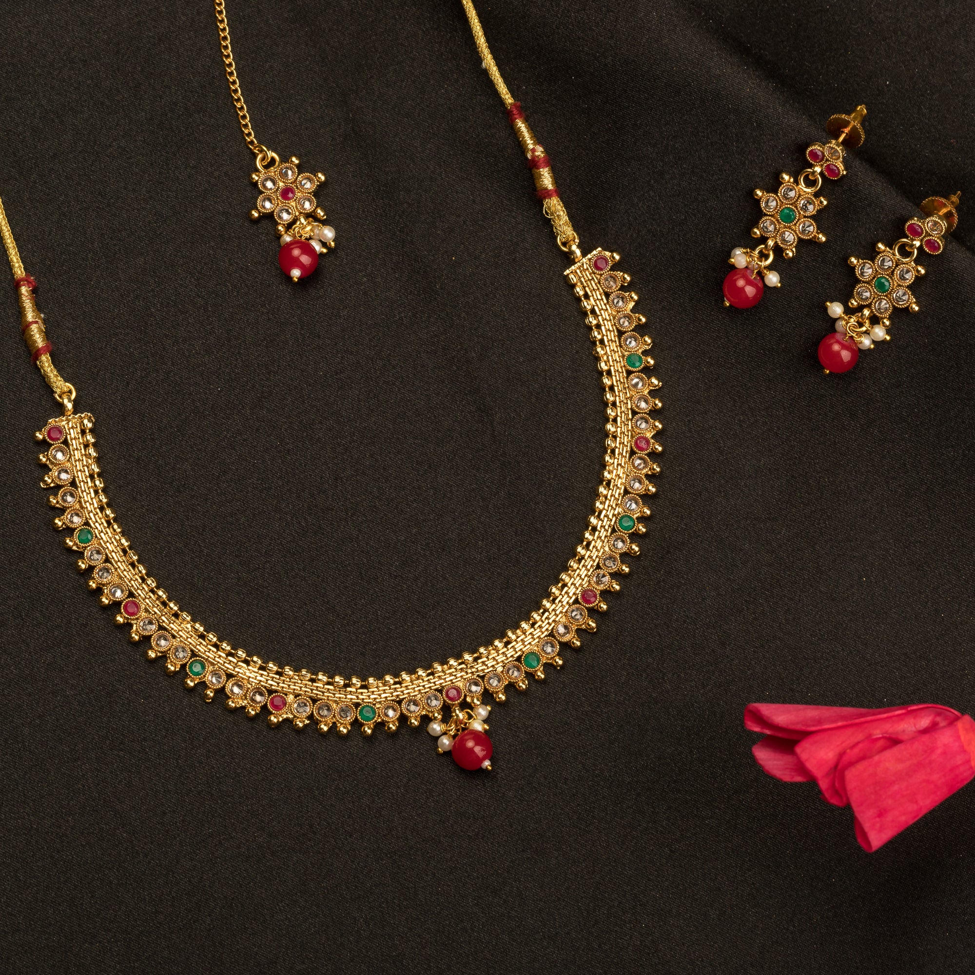 Gold-tone necklace with matching Maang Tikka offers a traditional and elegant festival ensemble.