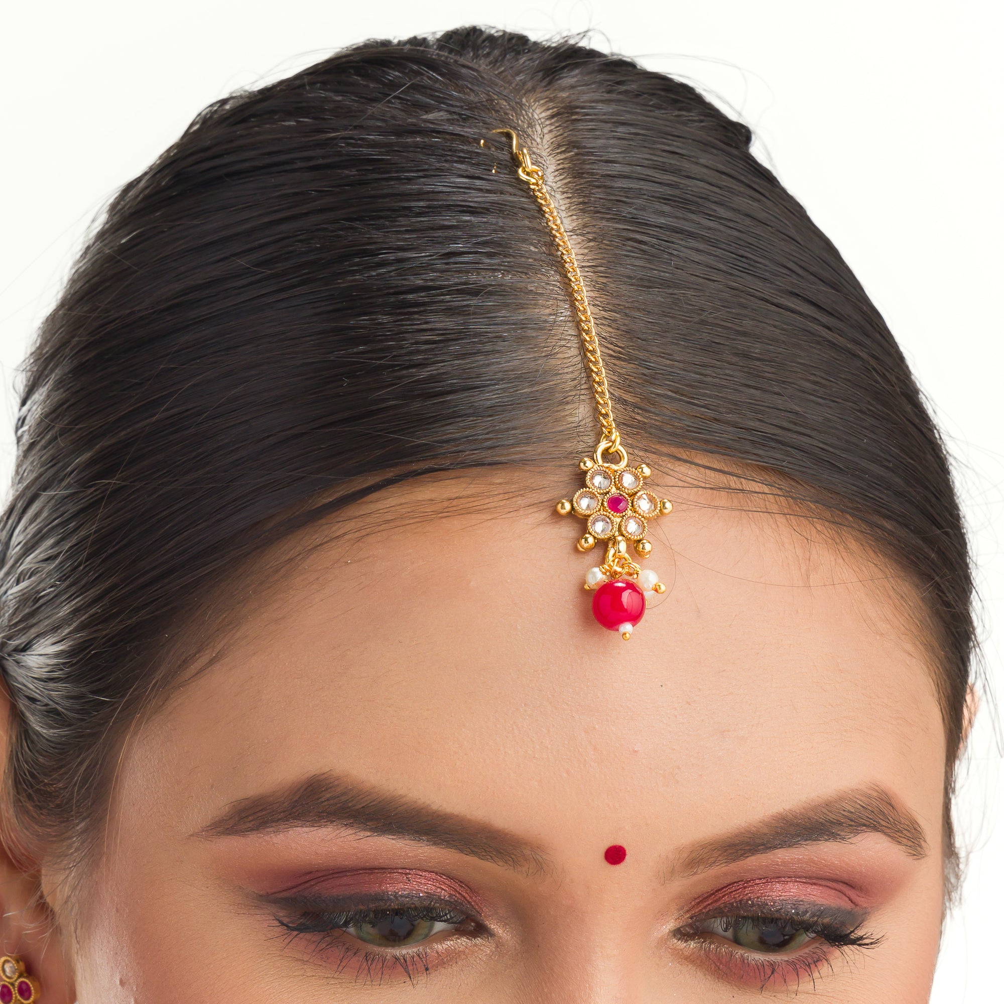 Gold-tone necklace with matching Maang Tikka offers a traditional and elegant festival ensemble.