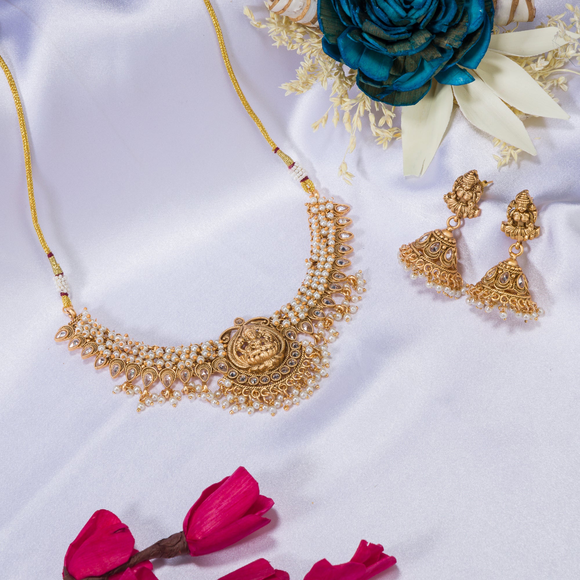 Graceful temple necklace with white pearls adds a touch of classic festival sophistication.