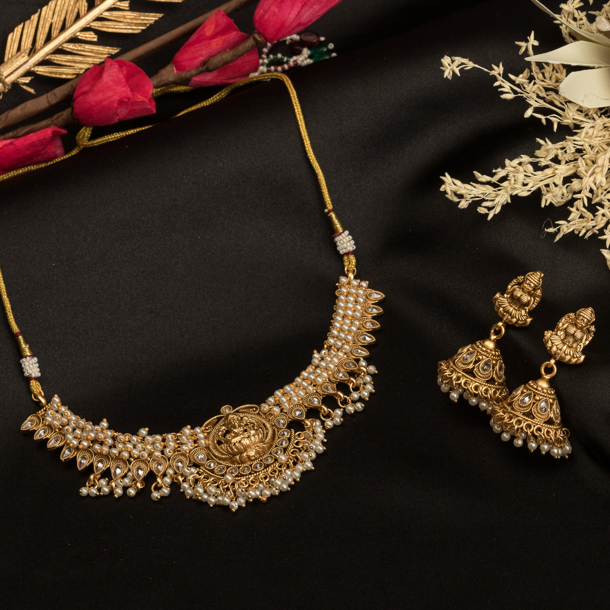 Graceful temple necklace with white pearls adds a touch of classic festival sophistication.