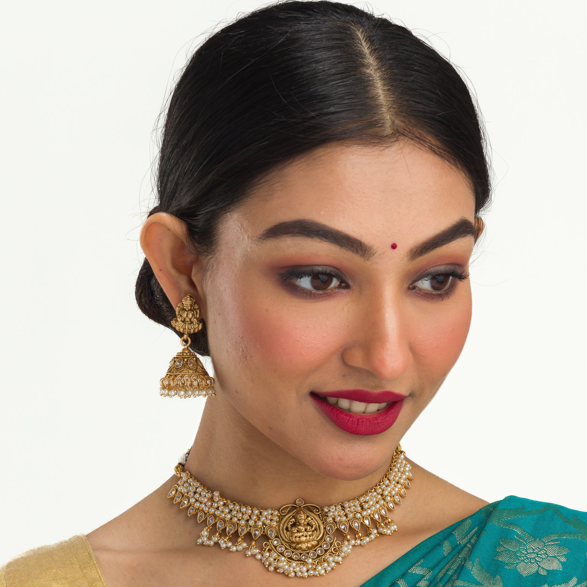 Graceful temple necklace with white pearls adds a touch of classic festival sophistication.