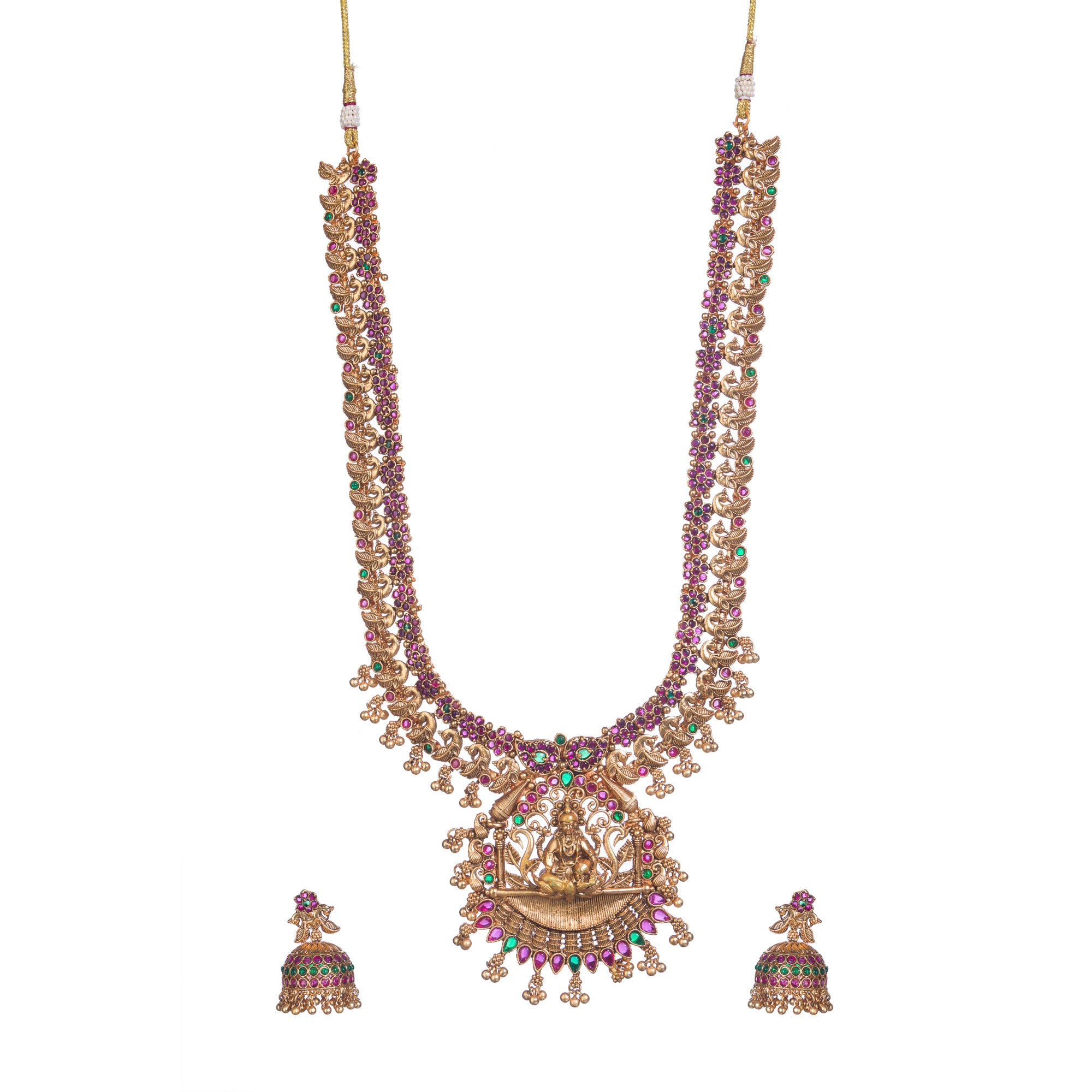 Traditional temple jewelry with red and green stones radiates timeless opulence and charm.