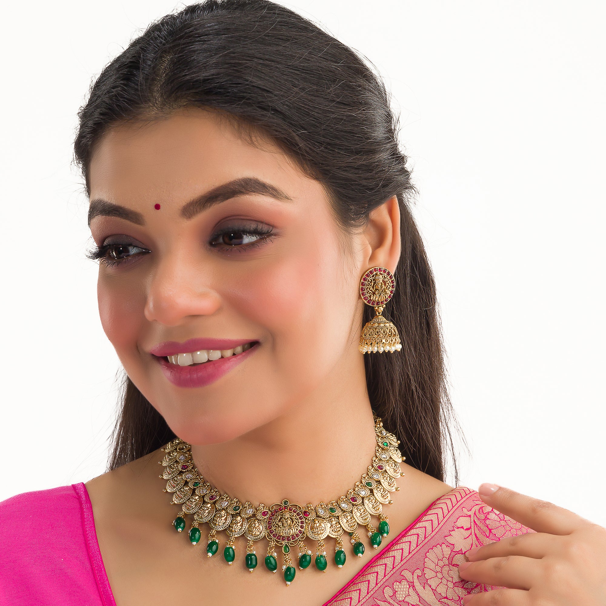 Temple necklace with green Kundan stones radiates vibrant, traditional festival elegance.