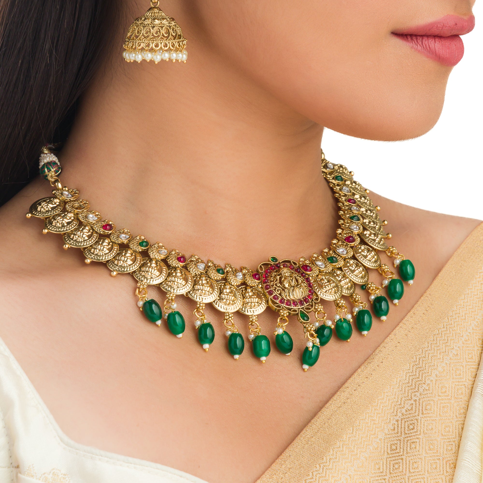 Temple necklace with green Kundan stones radiates vibrant, traditional festival elegance.