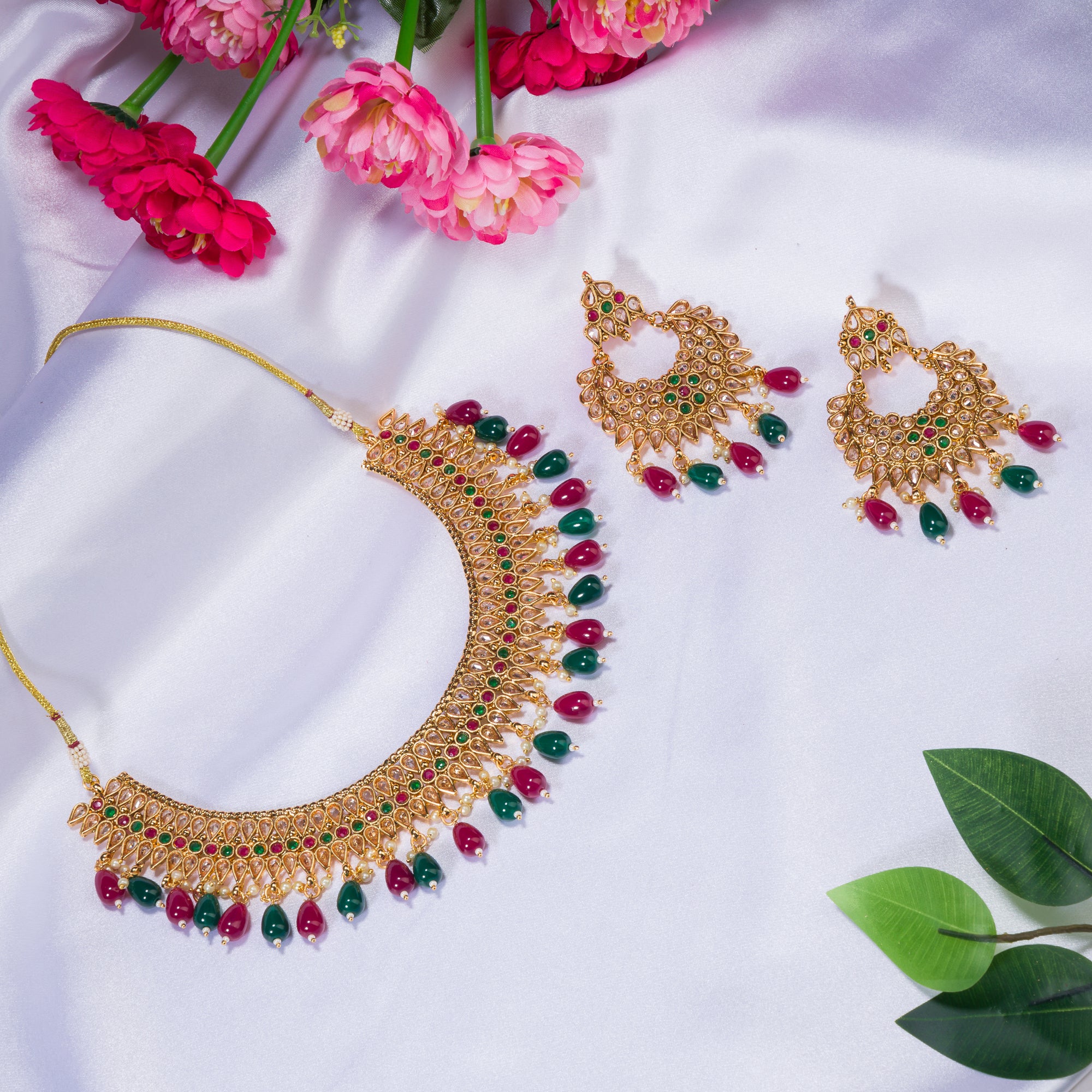 Kundan choker with maroon and green stones offers a regal and vibrant festival look.