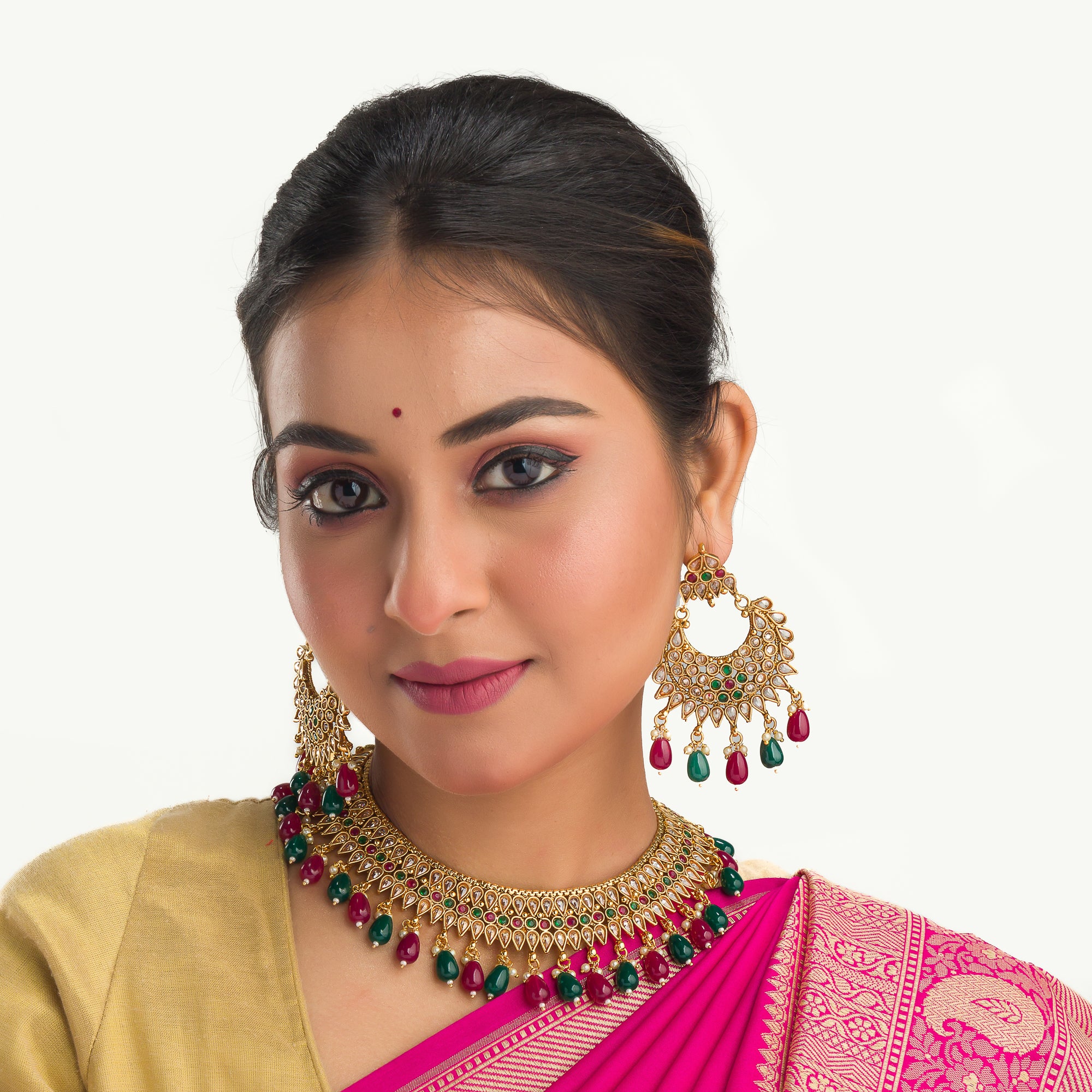 Kundan choker with maroon and green stones offers a regal and vibrant festival look.