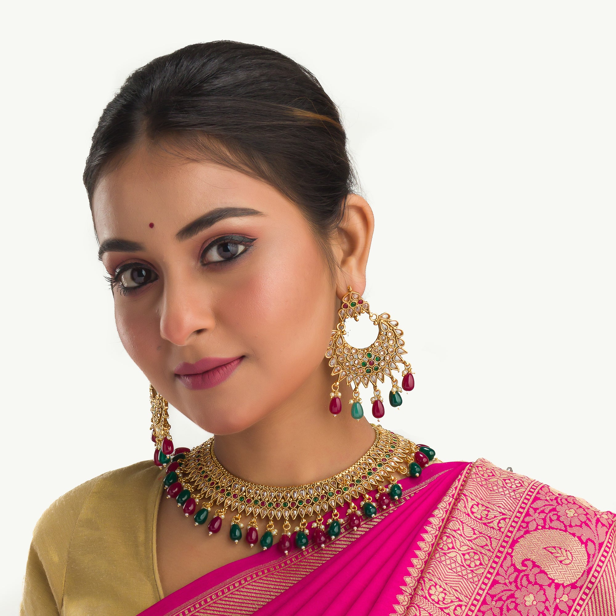 Kundan choker with maroon and green stones offers a regal and vibrant festival look.