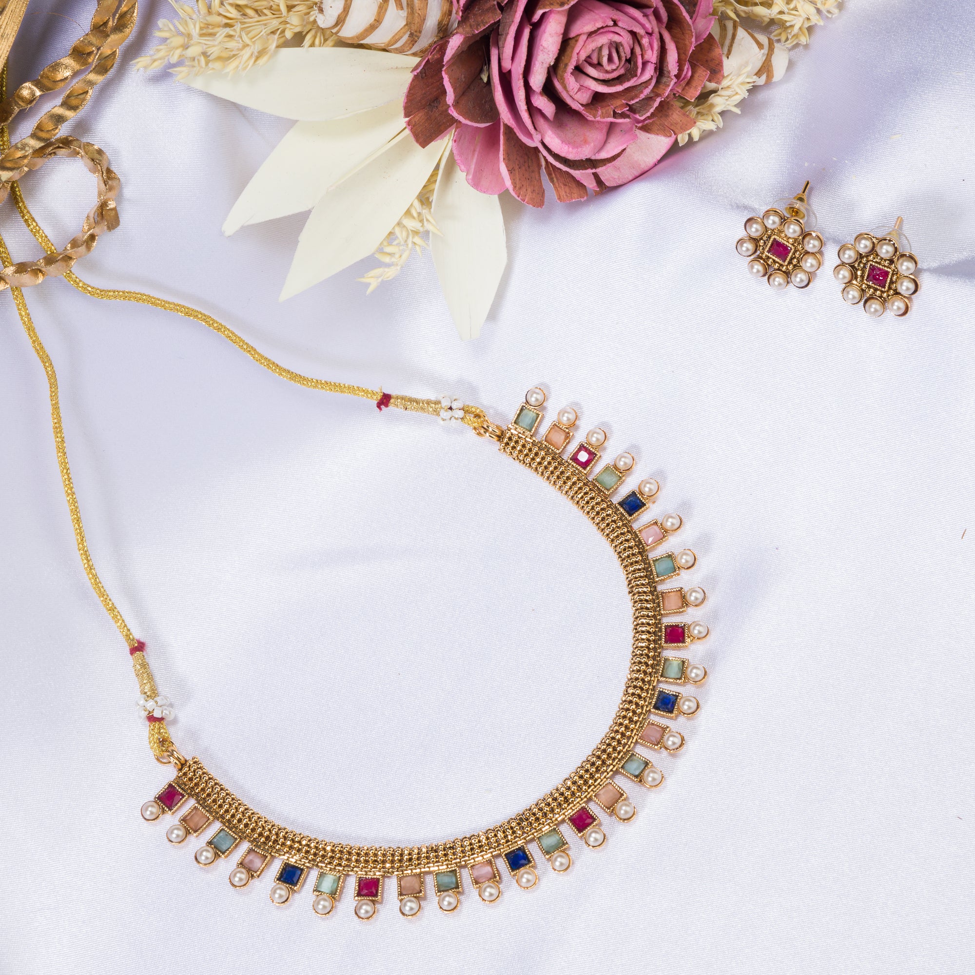 Short necklace with vibrant multi-color stones brings playful flair to festive attire.