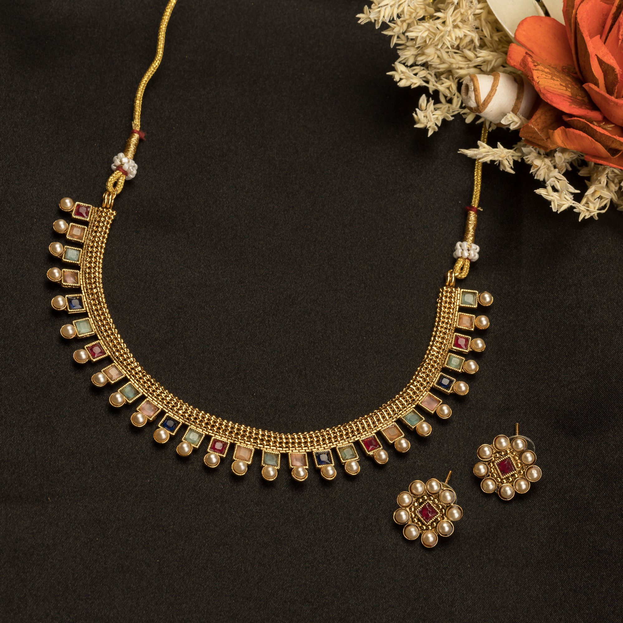 Short necklace with vibrant multi-color stones brings playful flair to festive attire.