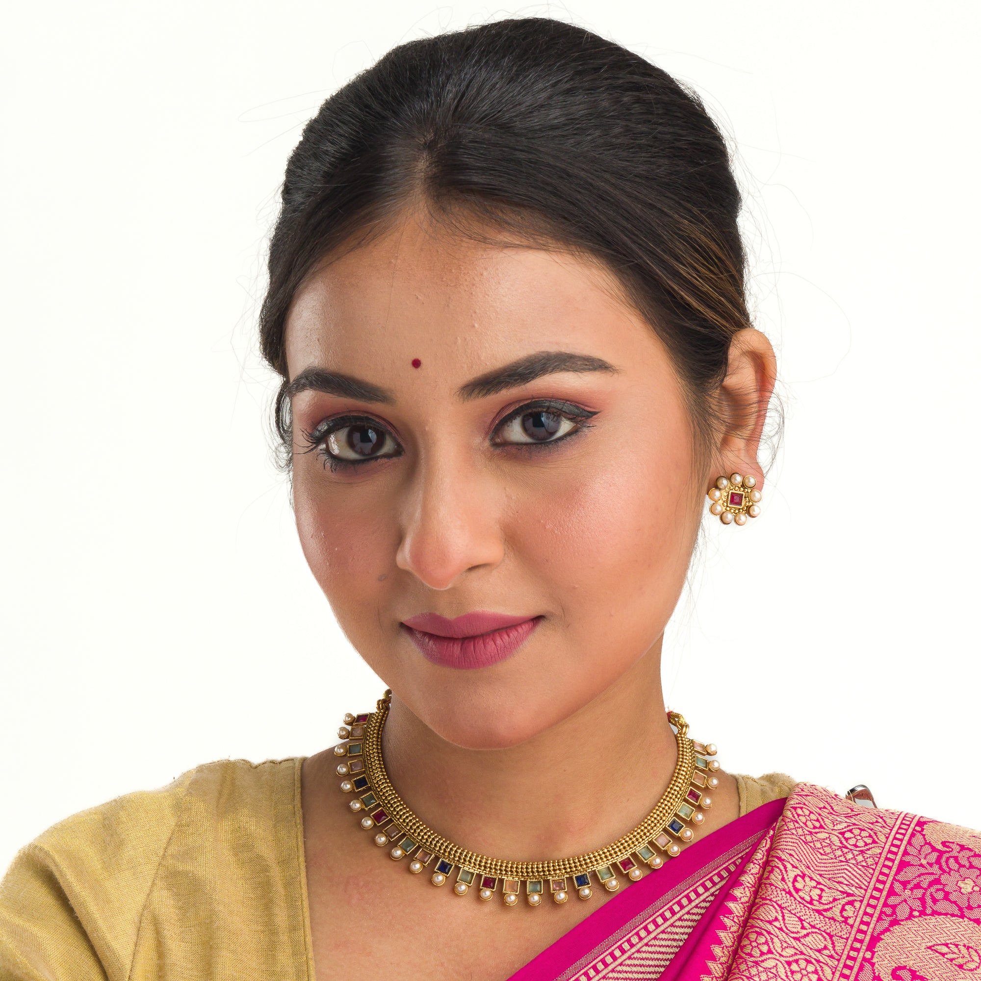 Short necklace with vibrant multi-color stones brings playful flair to festive attire.