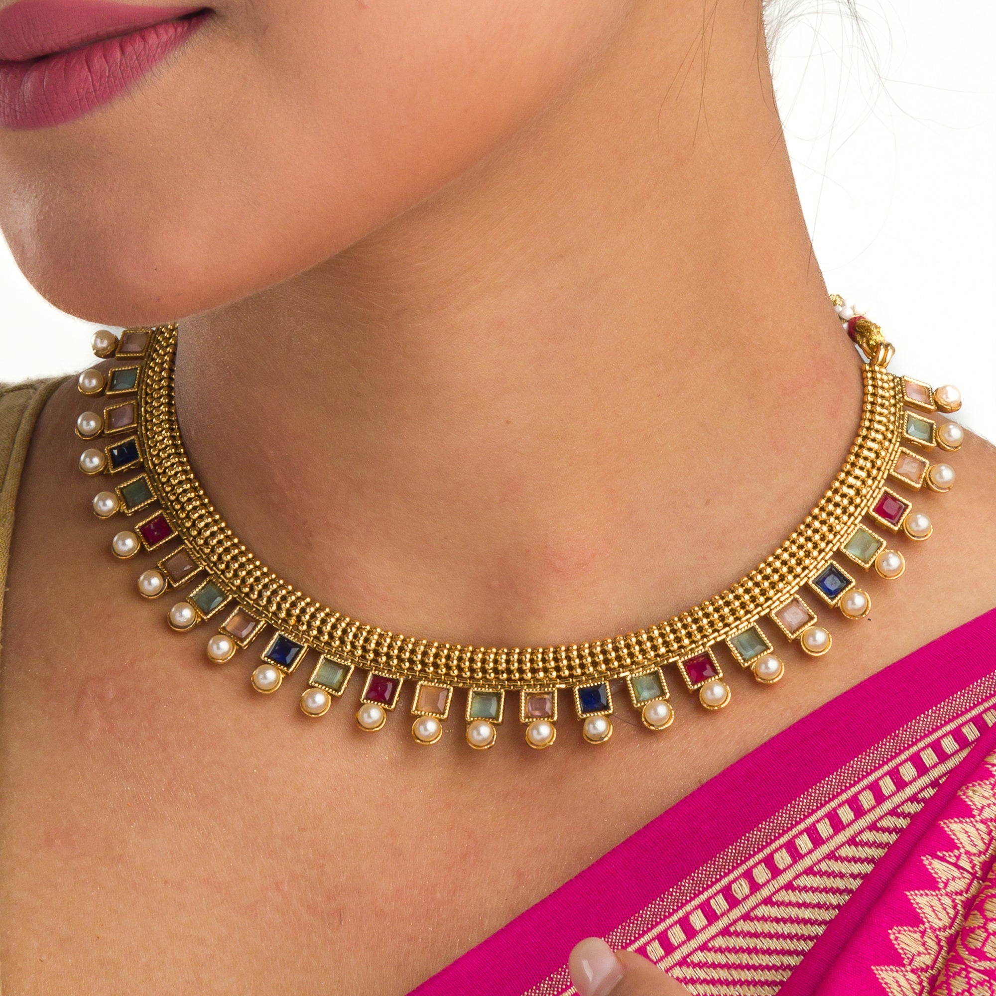 Short necklace with vibrant multi-color stones brings playful flair to festive attire.