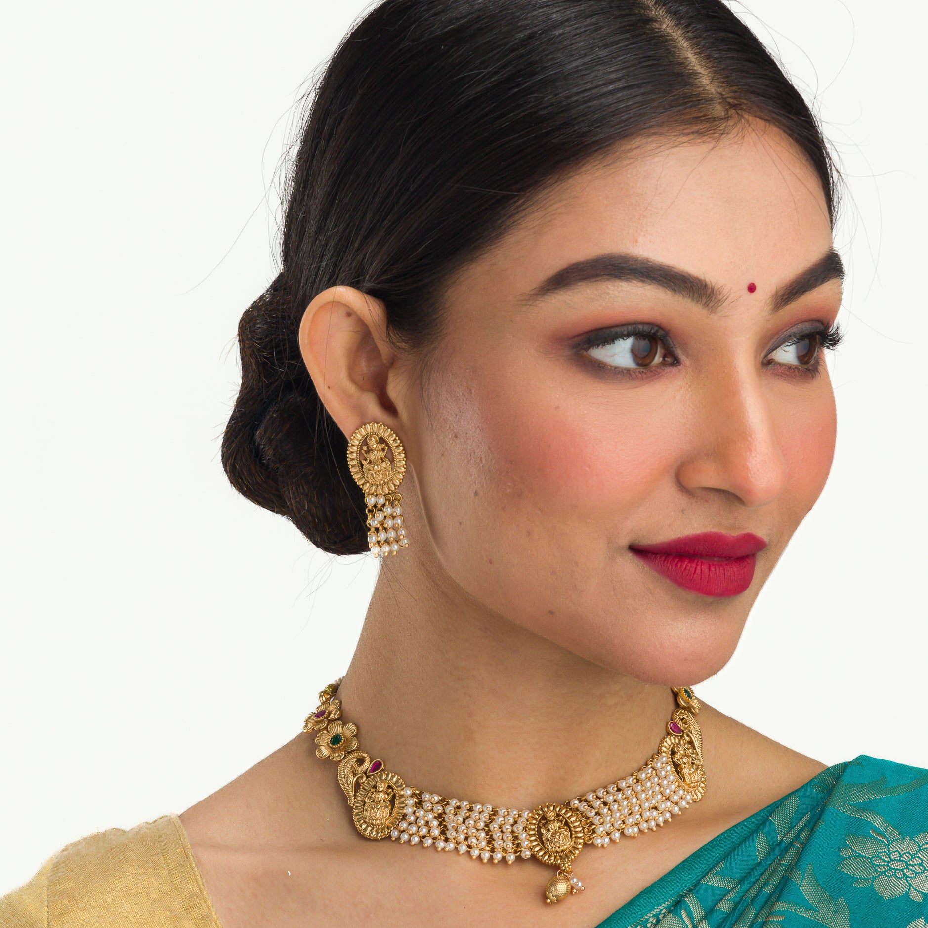 Temple necklace with intricate craftsmanship adds timeless elegance to your festive ensemble.