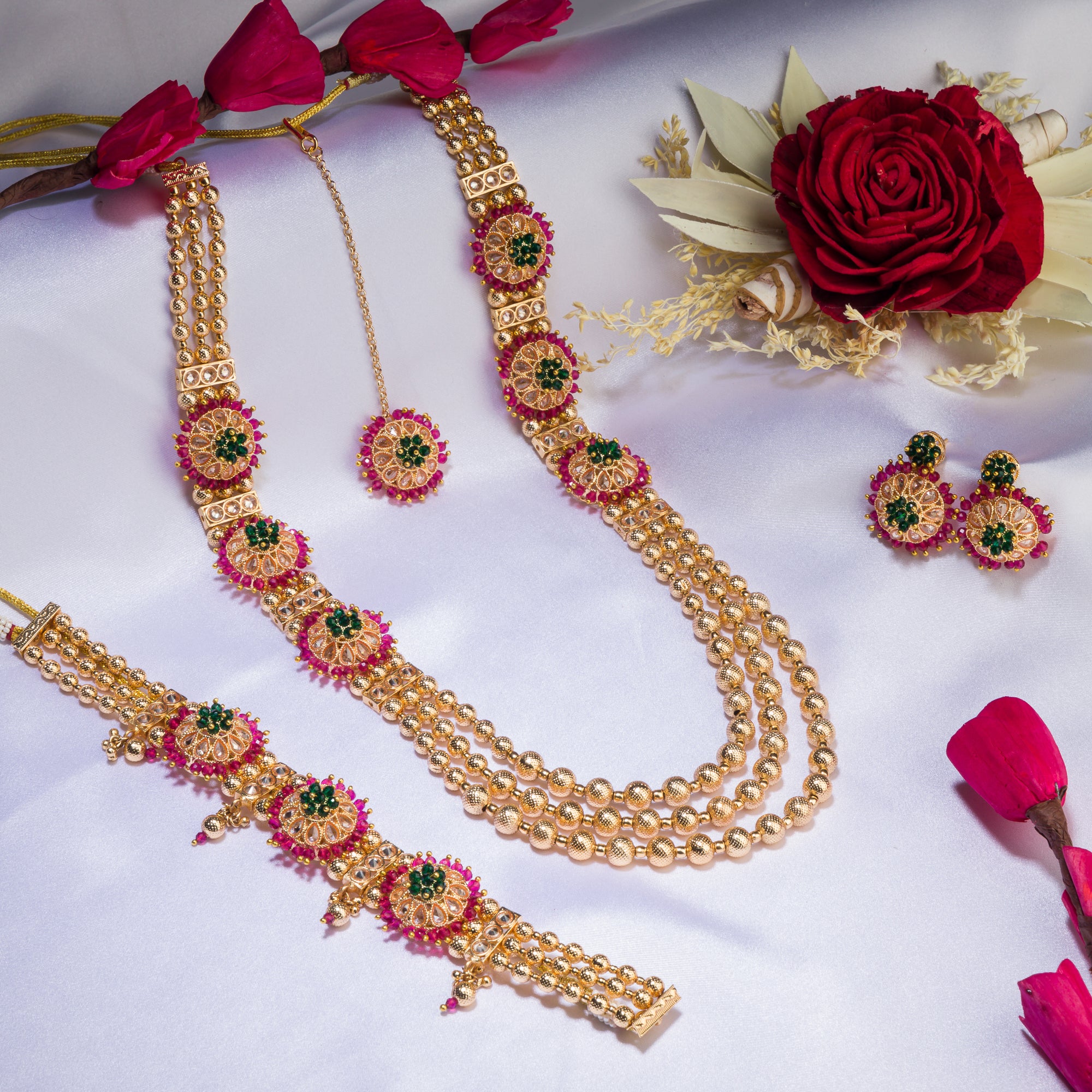 Kundan choker with maroon and green stones offers a regal and vibrant festival look.