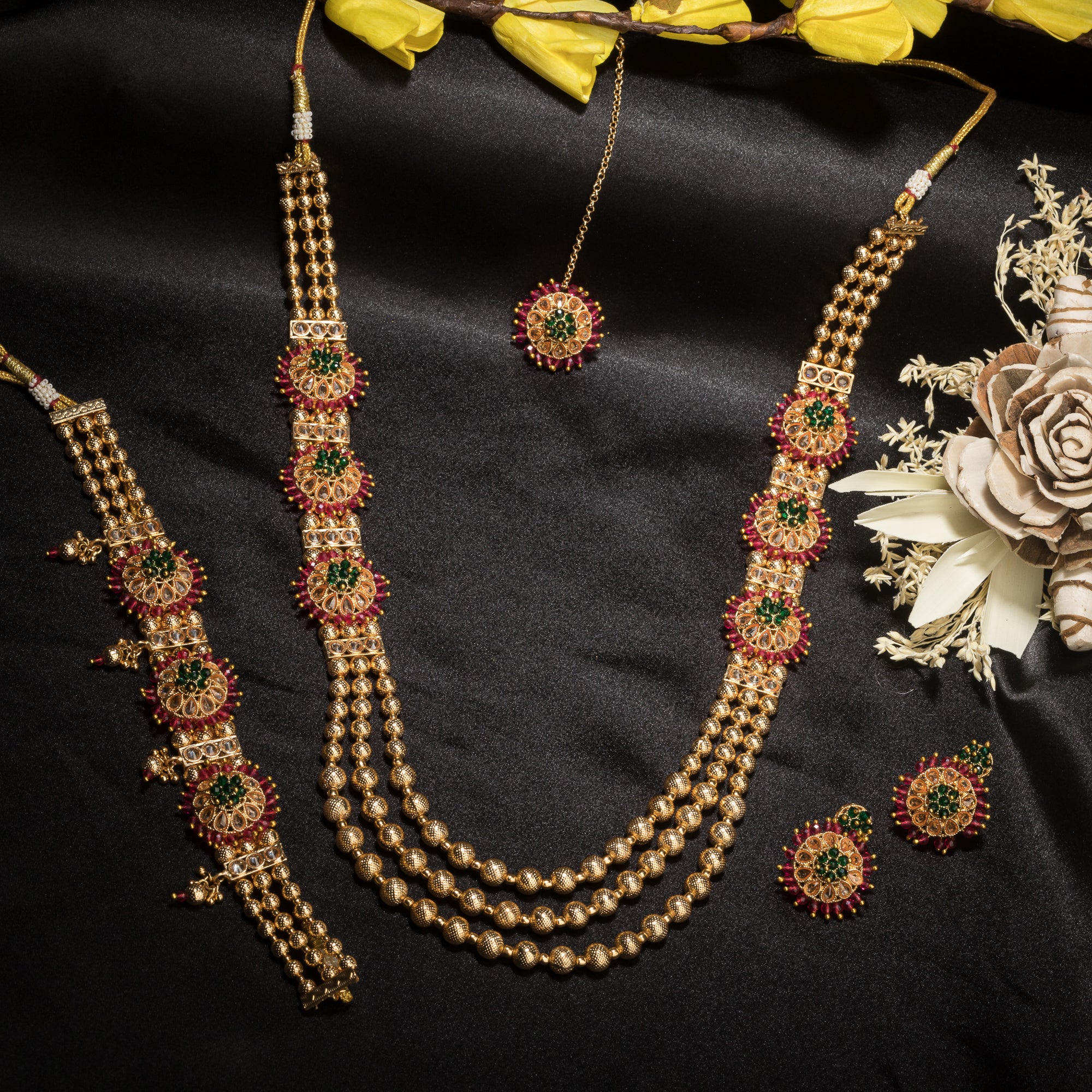 Kundan choker with maroon and green stones offers a regal and vibrant festival look.