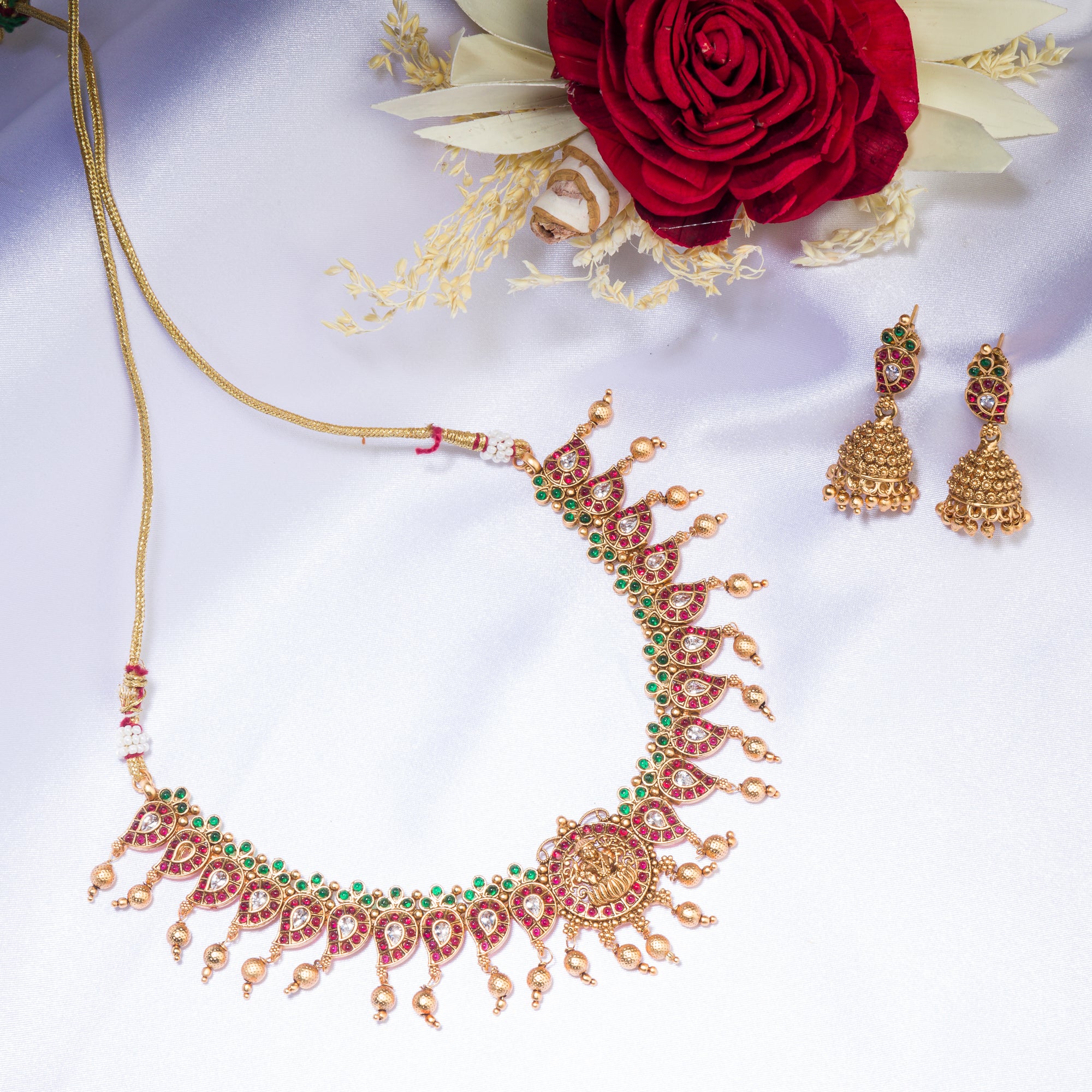 Gold long necklace with multi-color stones exudes vibrant elegance for a festive celebration.