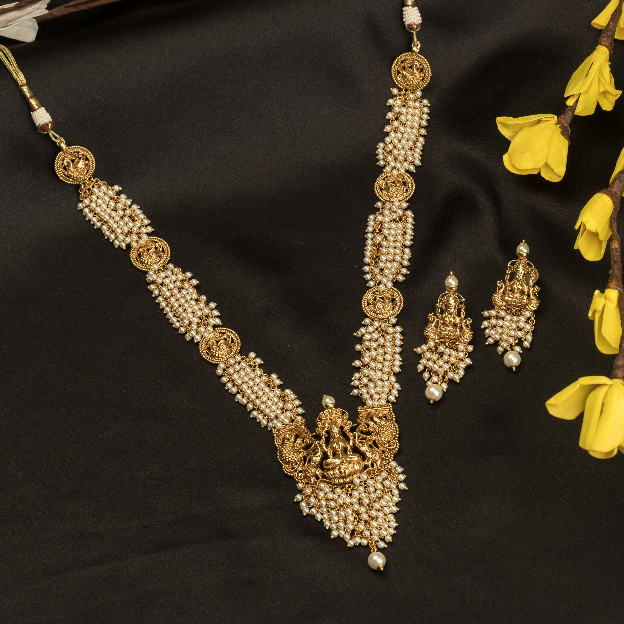 Luxurious temple long necklace with white pearls radiates opulence and refined elegance for festivals.