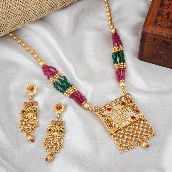 Vibrant gold long necklace with multicolor stones enhances festive attire with vibrant elegance