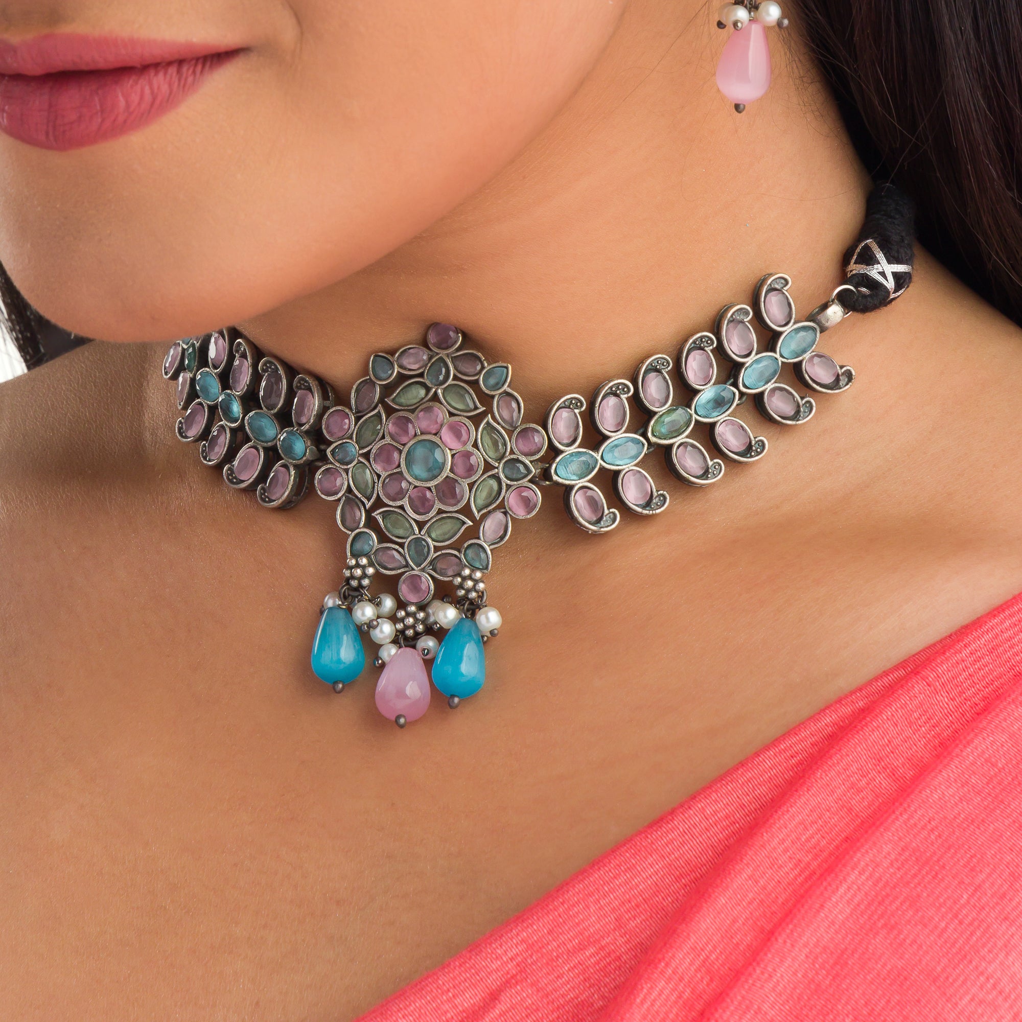 "Oxidized choker with multicolor stones adds a unique and vibrant touch for festive occasions."