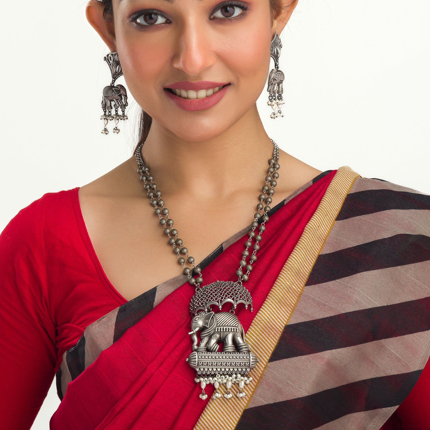 "Oxidized long necklace with umbrella, elephant motifs, and white pearls exudes vintage elegance."