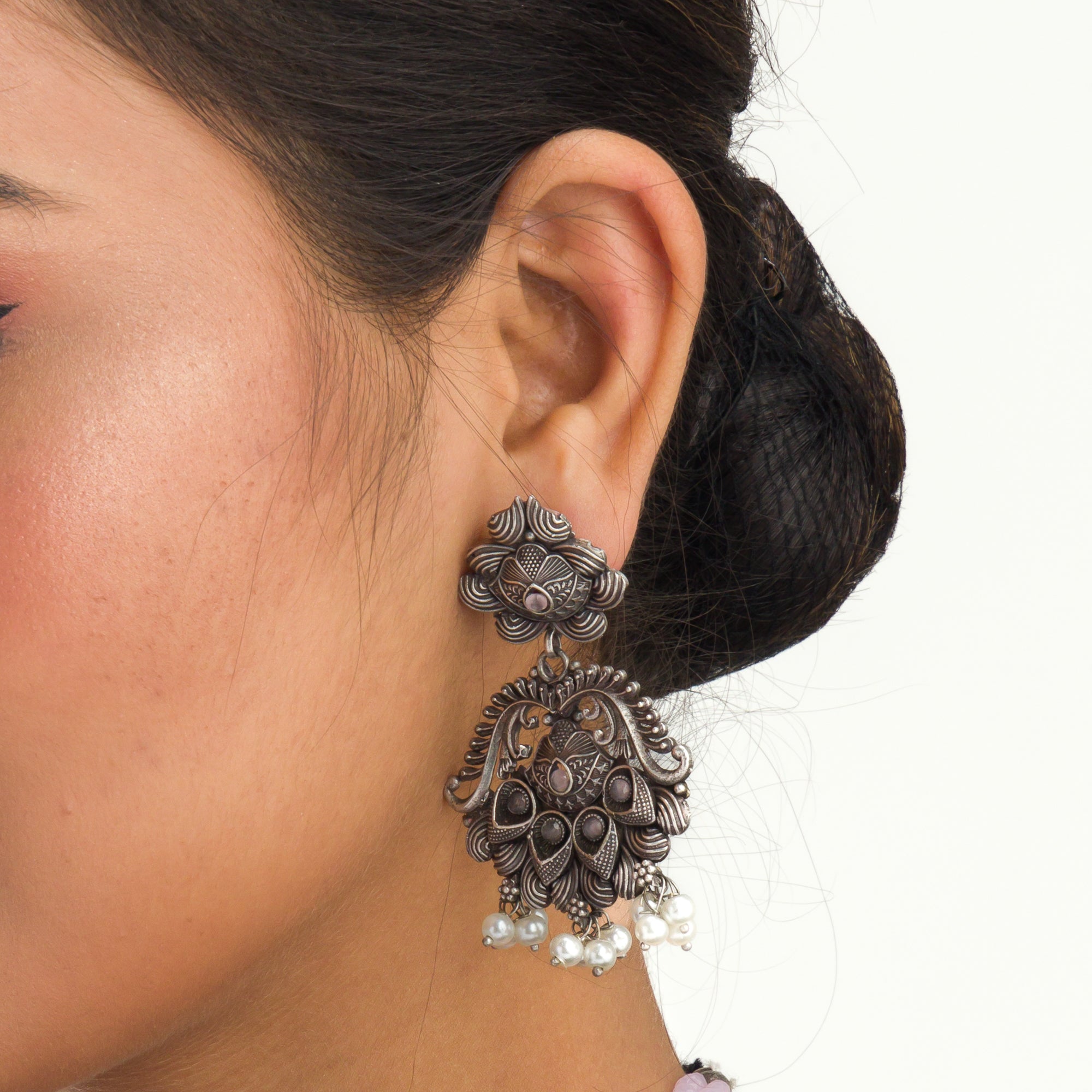 "Long oxidized necklace with pink and white pearls adds vintage elegance."