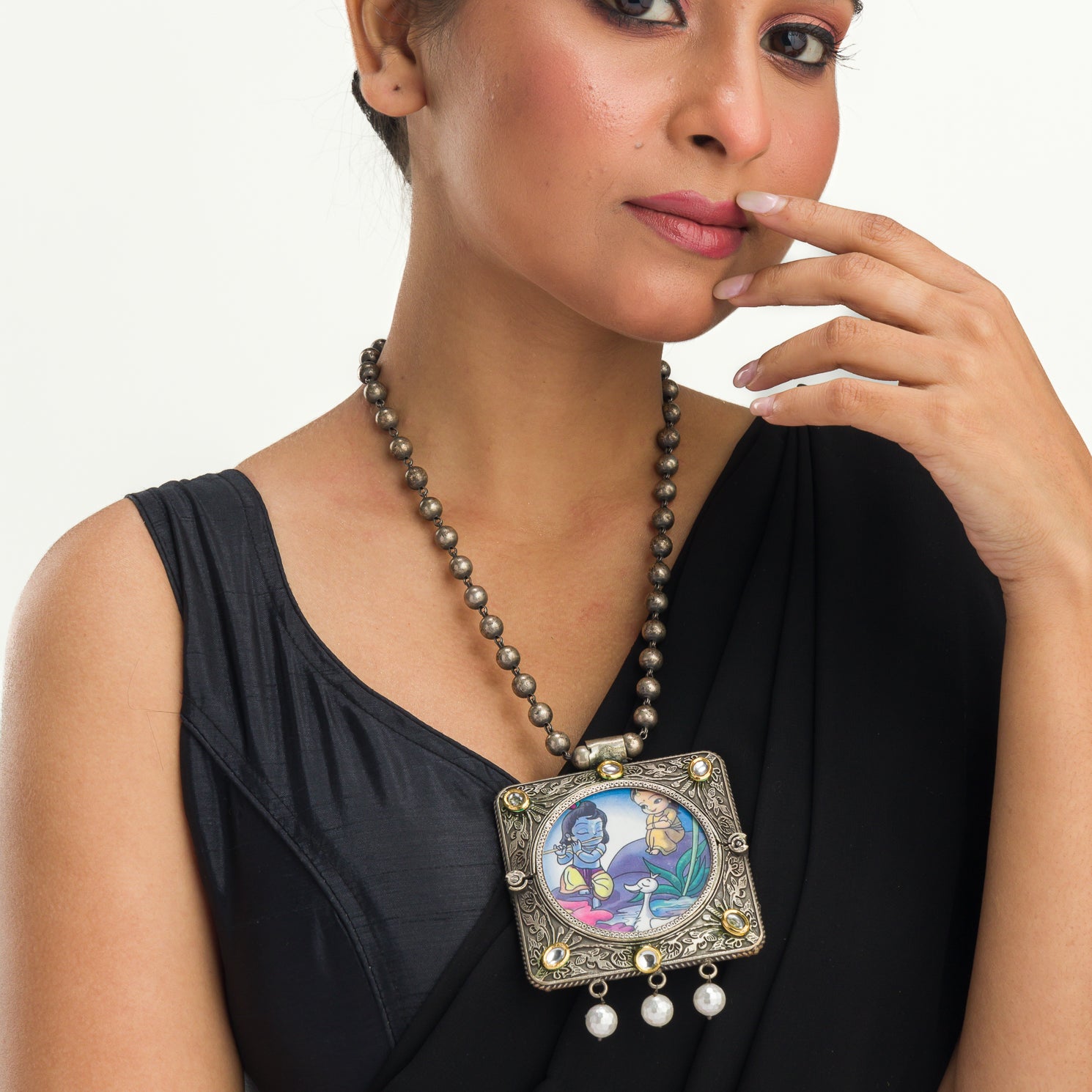 "Oxidized long necklace with Radha Krishna image brings spiritual charm."