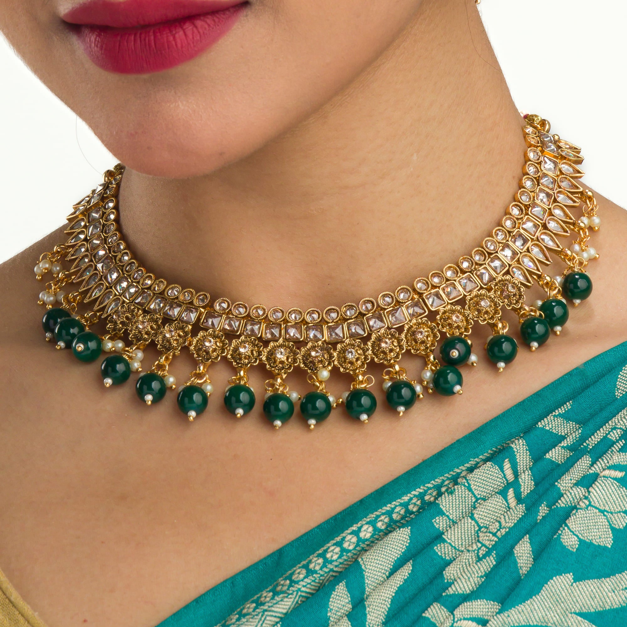 "Stylish gold-tone necklace with green Kundan for vibrant, elegant appeal."