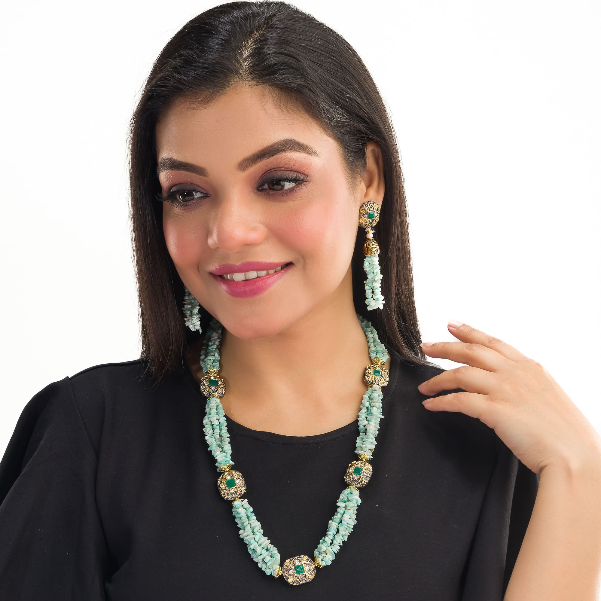 "Gold-tone long necklace with green sea stone offers a refreshing, natural touch."