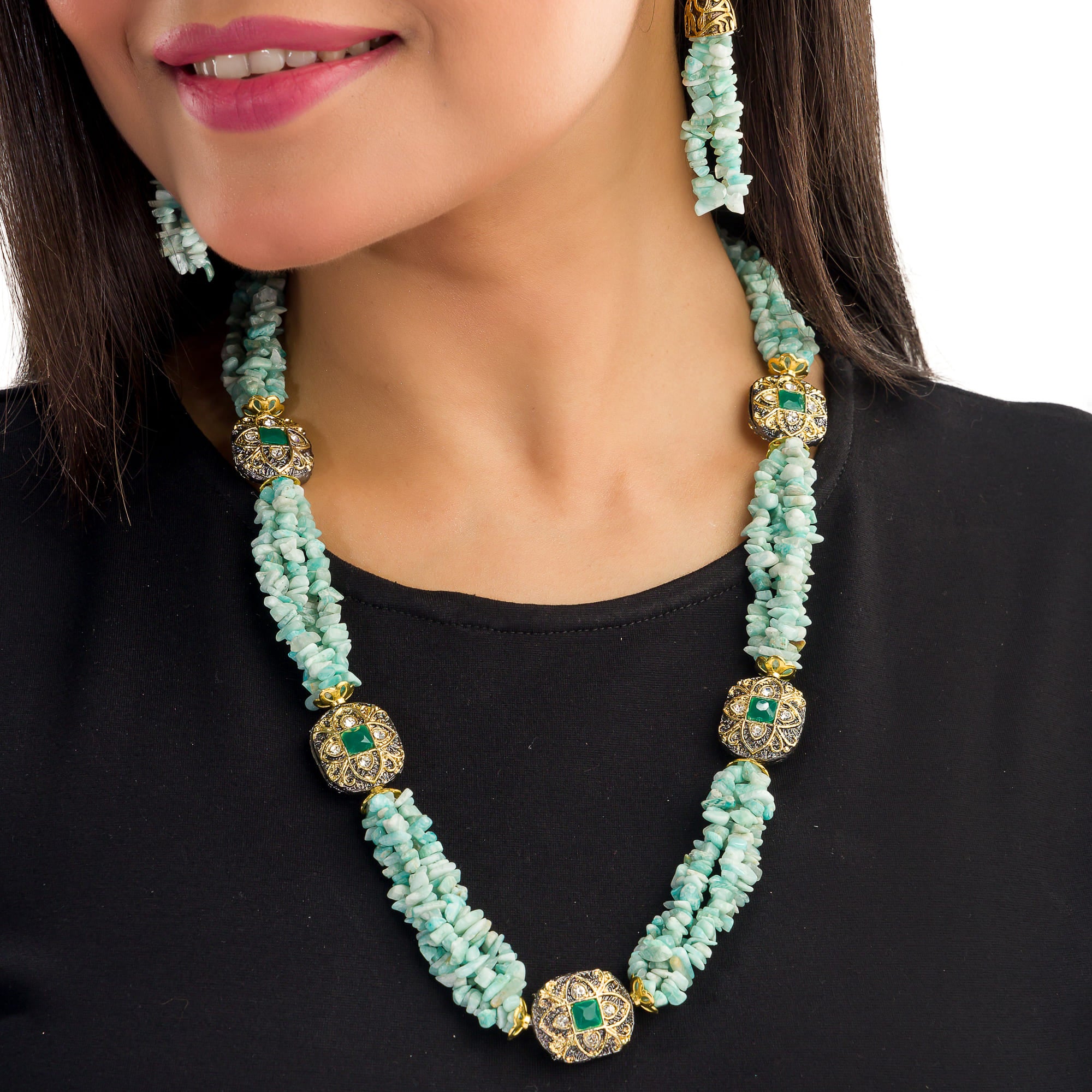 "Gold-tone long necklace with green sea stone offers a refreshing, natural touch."