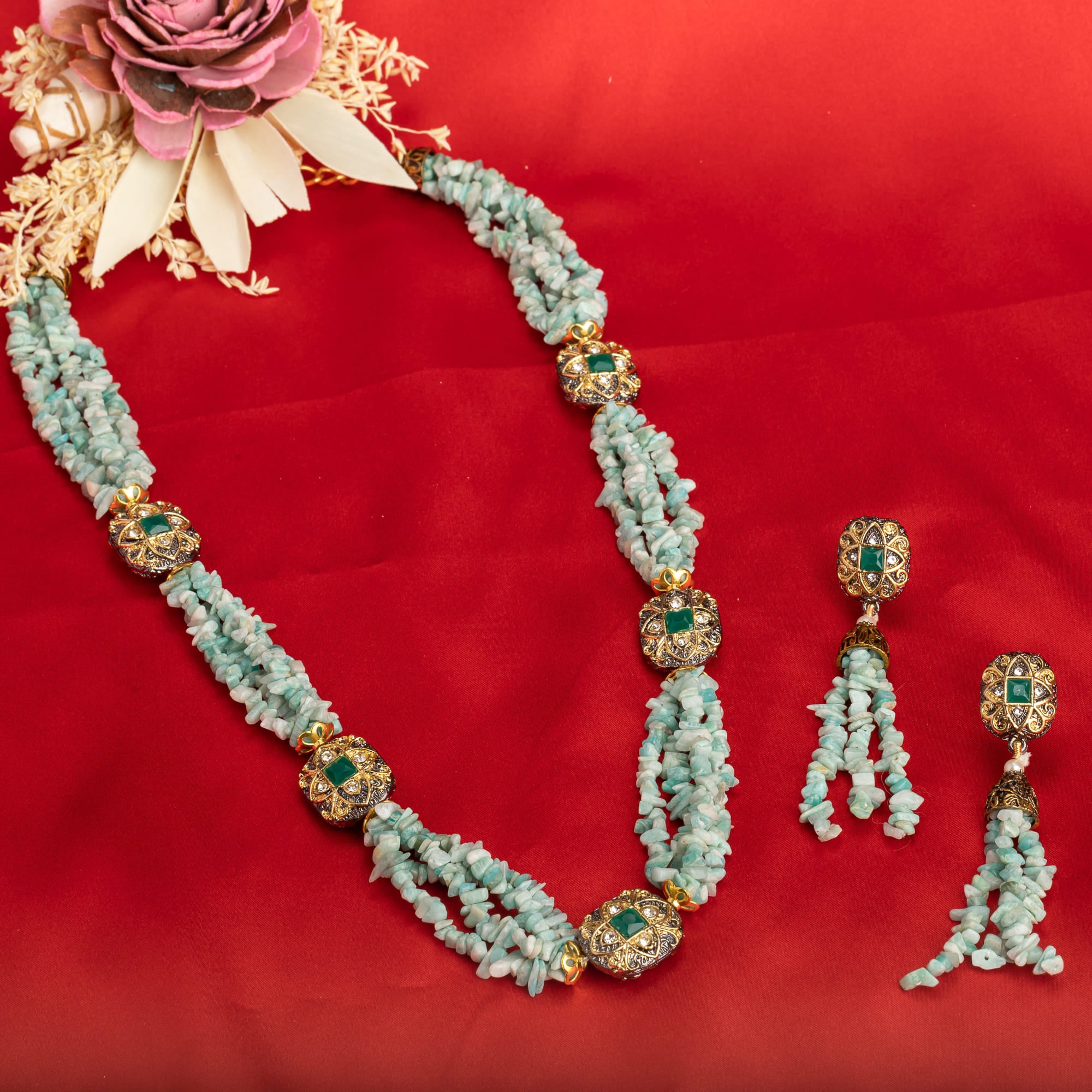 "Gold-tone long necklace with green sea stone offers a refreshing, natural touch."