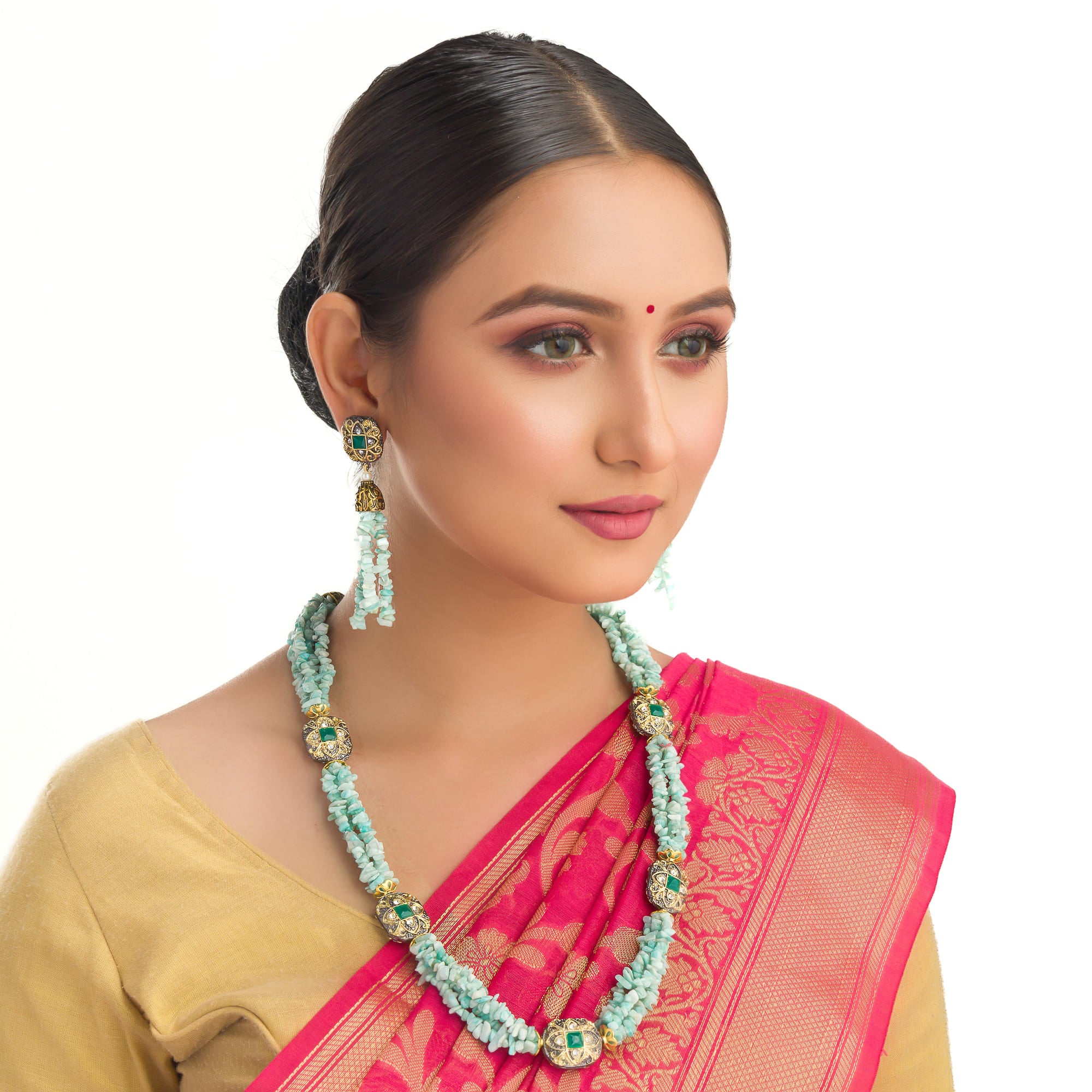 "Gold-tone long necklace with green sea stone offers a refreshing, natural touch."