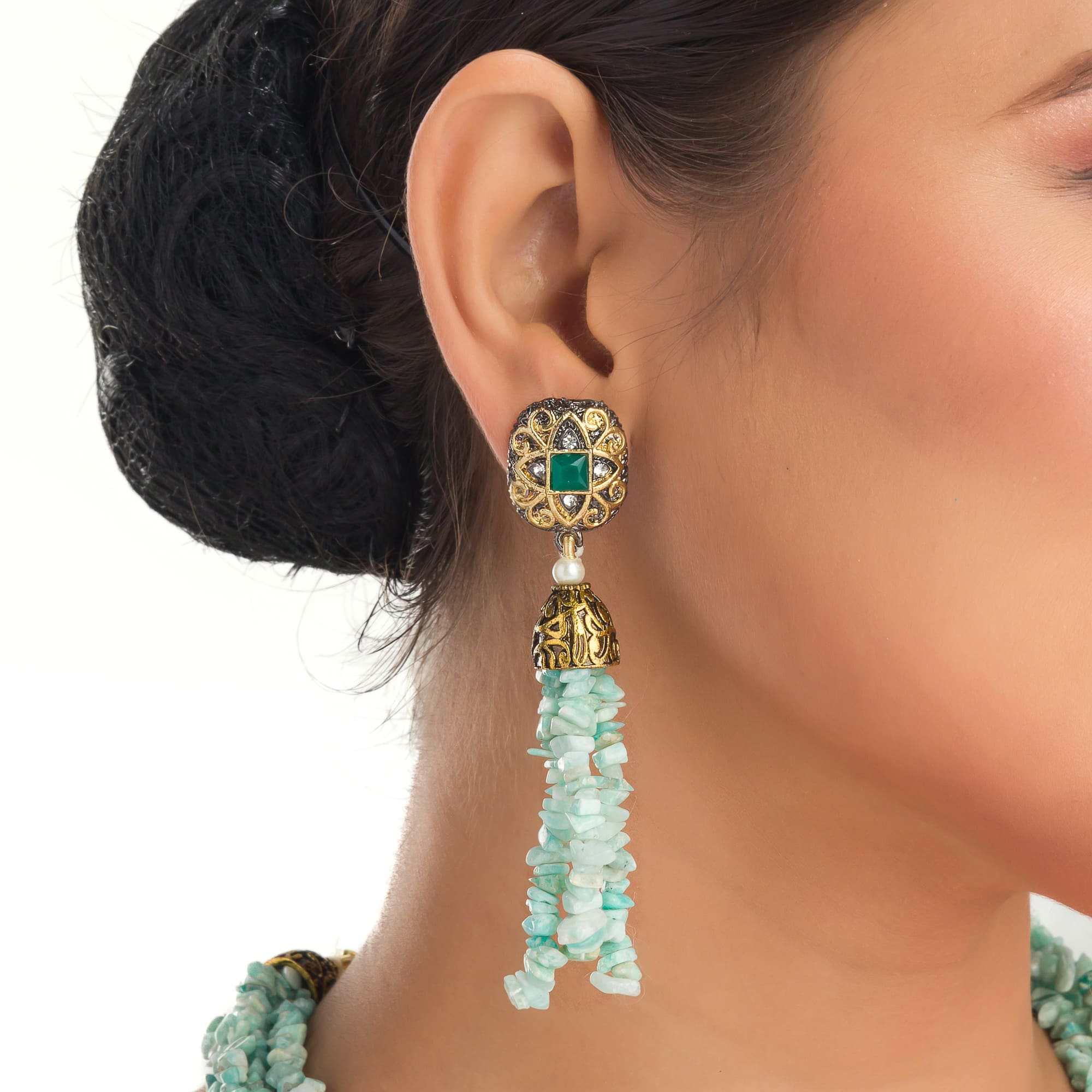 "Gold-tone long necklace with green sea stone offers a refreshing, natural touch."