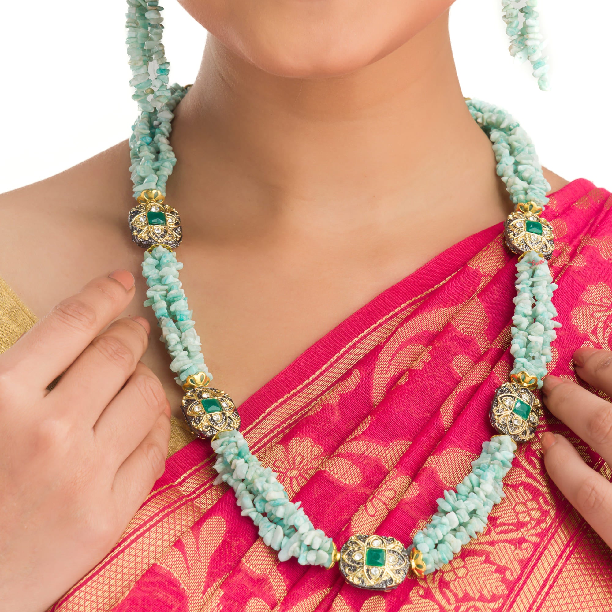 "Gold-tone long necklace with green sea stone offers a refreshing, natural touch."