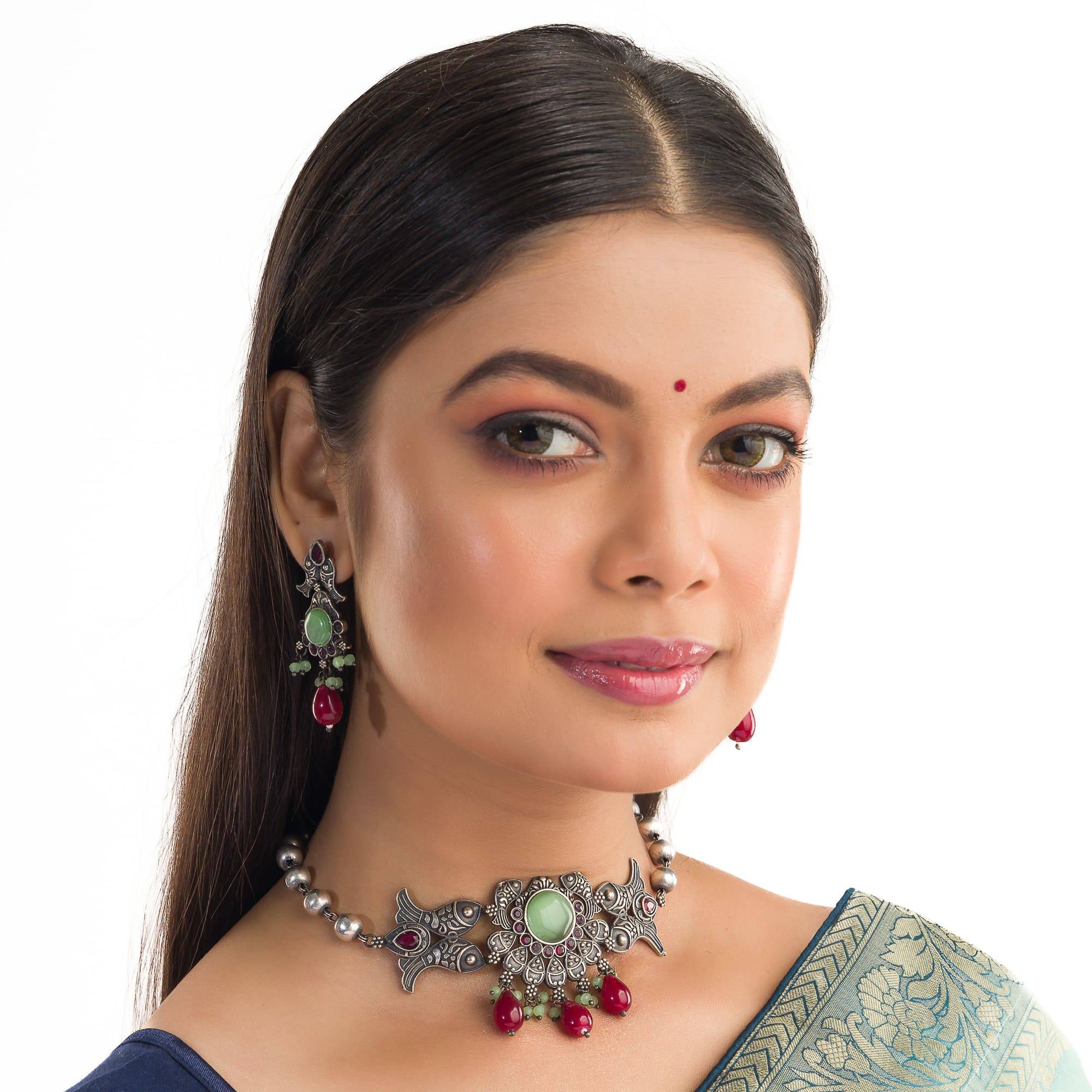 Oxidized choker with light green stones and maroon Kundan blends unique charm.