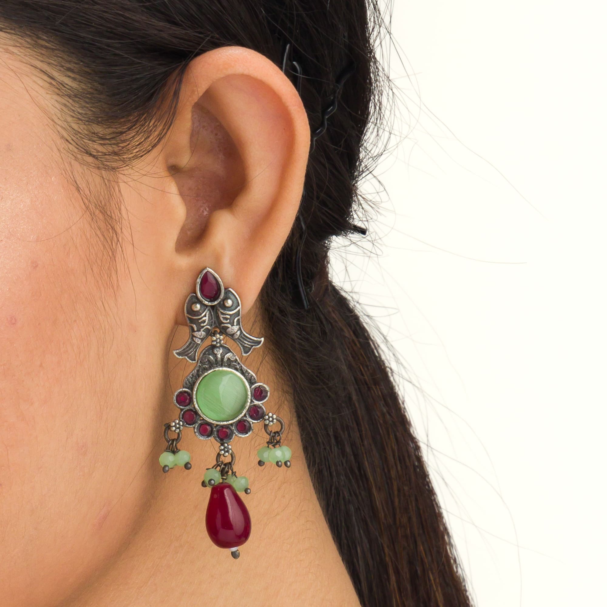 Oxidized choker with light green stones and maroon Kundan blends unique charm.