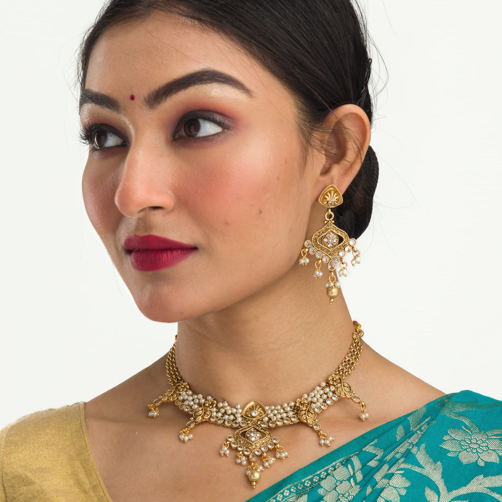 "Gold-tone necklace set with white pearls for a classic and elegant look."