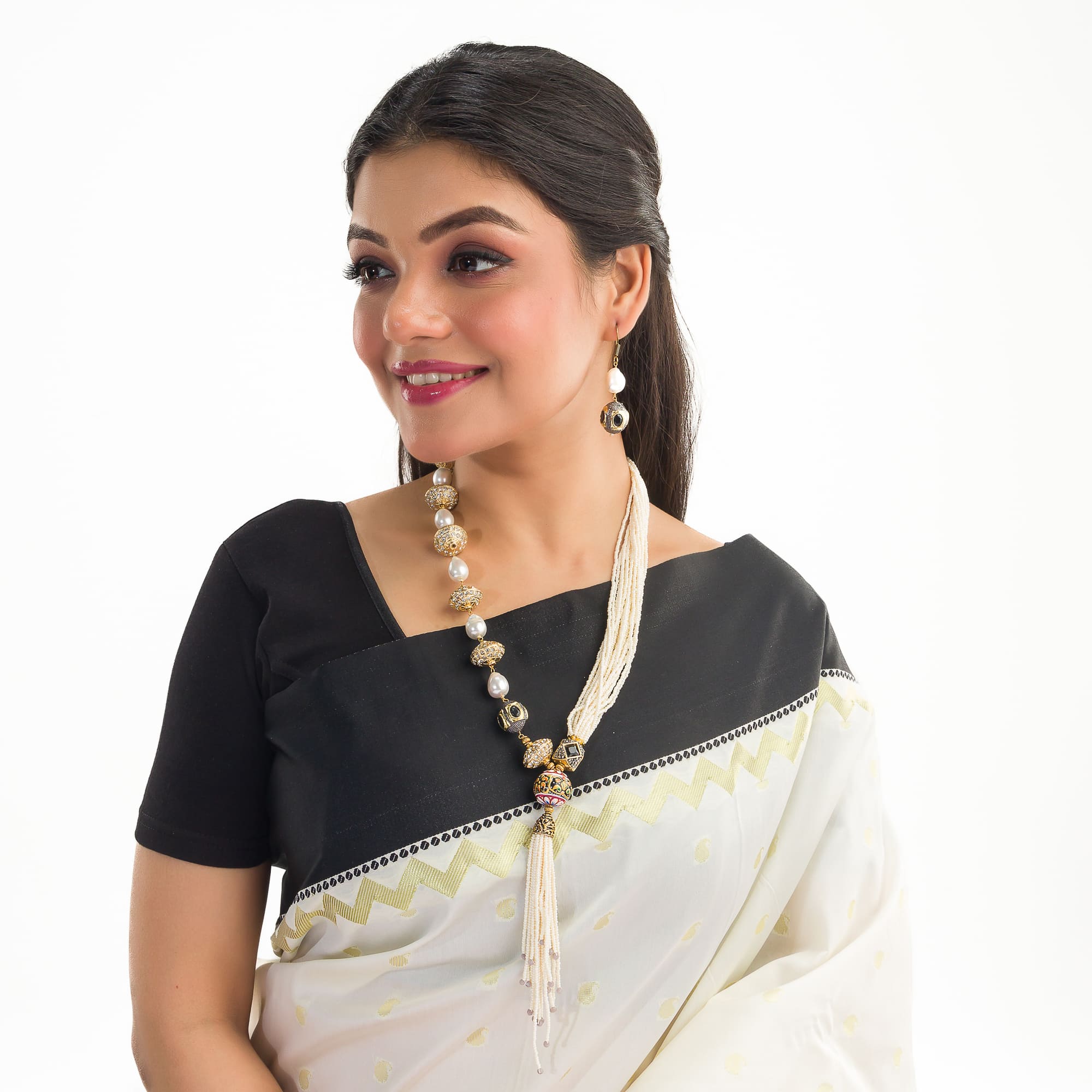 "Elegant white pearl long necklace with golden accents for a glamorous finish."