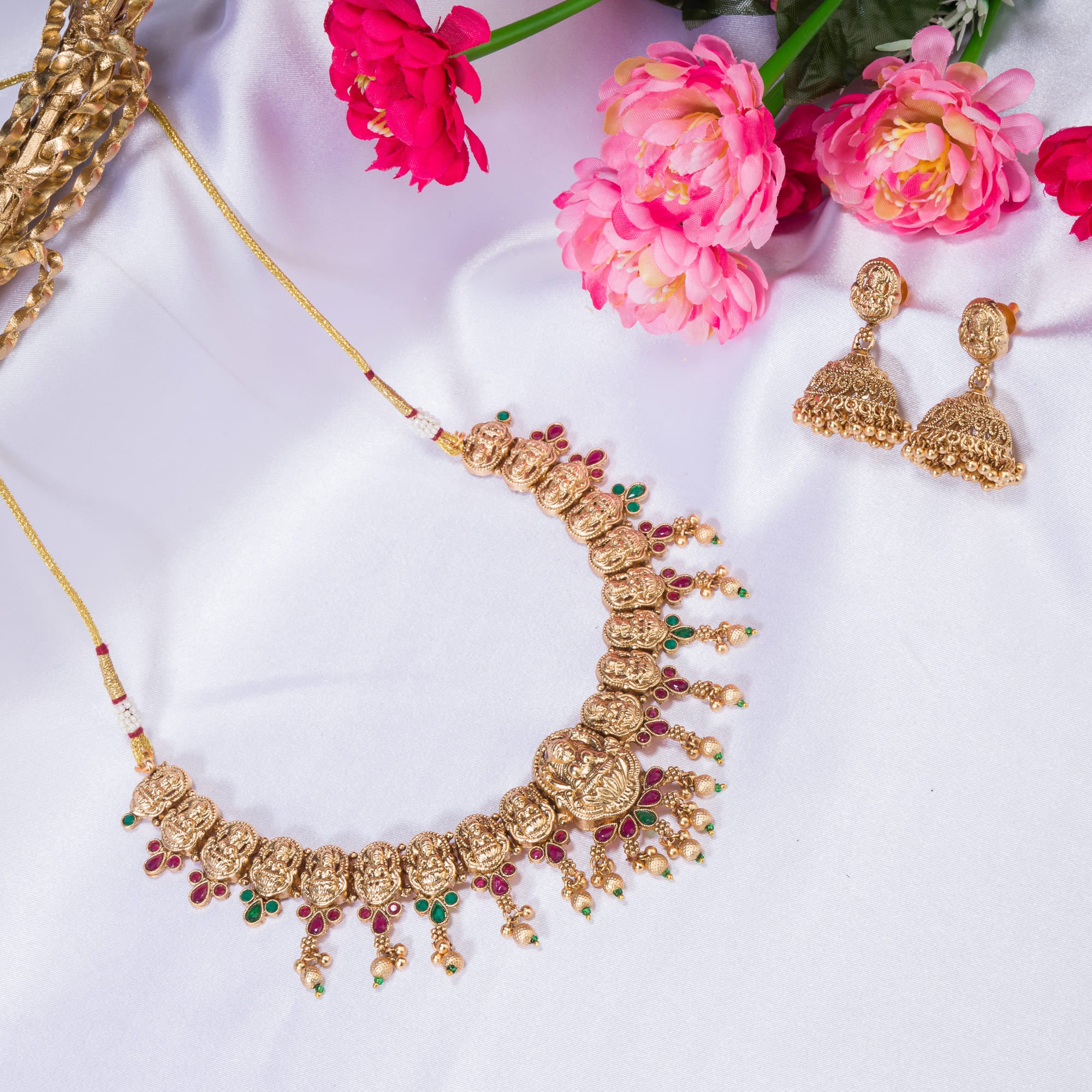 Gold-tone temple necklace set with golden beads offers timeless elegance