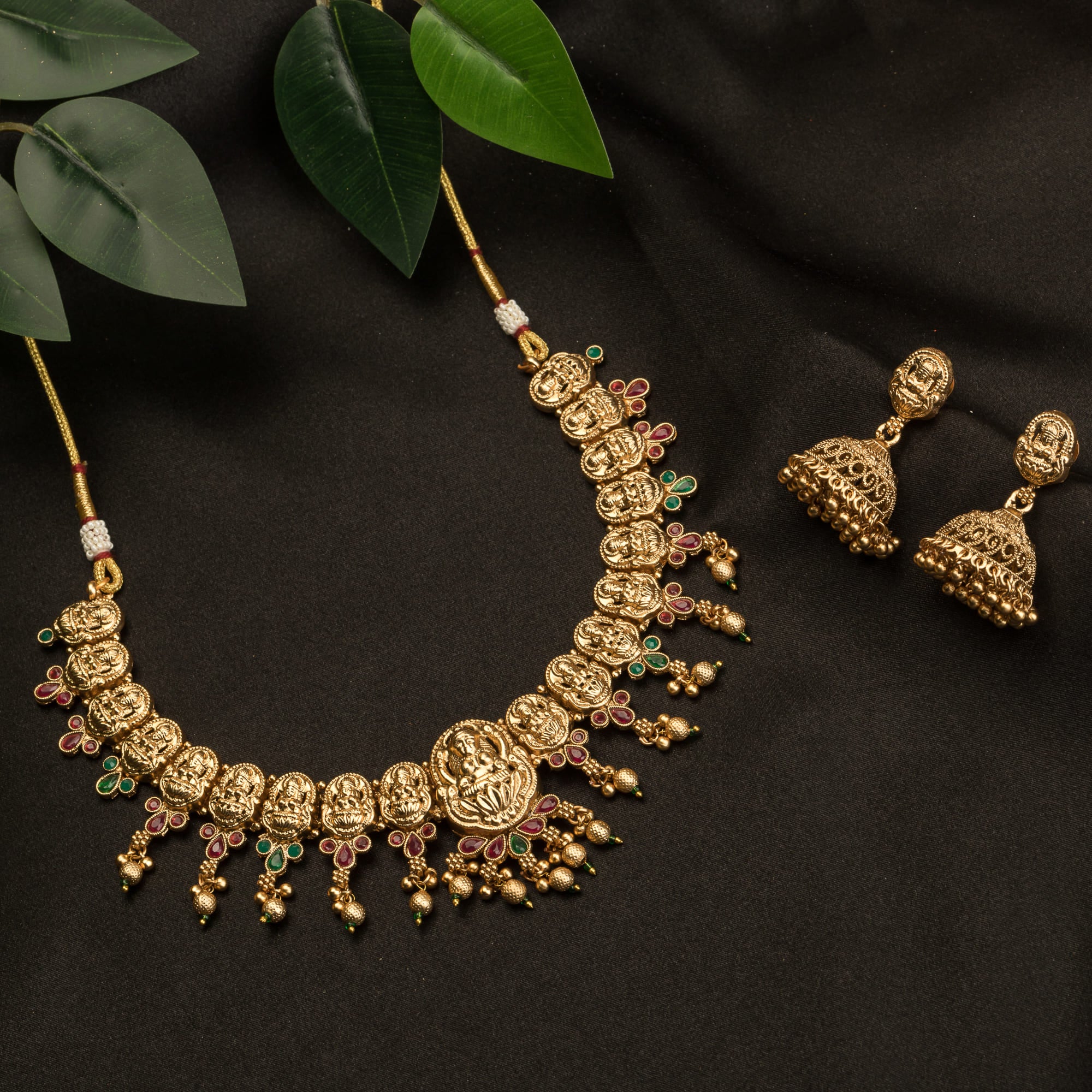 Gold-tone temple necklace set with golden beads offers timeless elegance