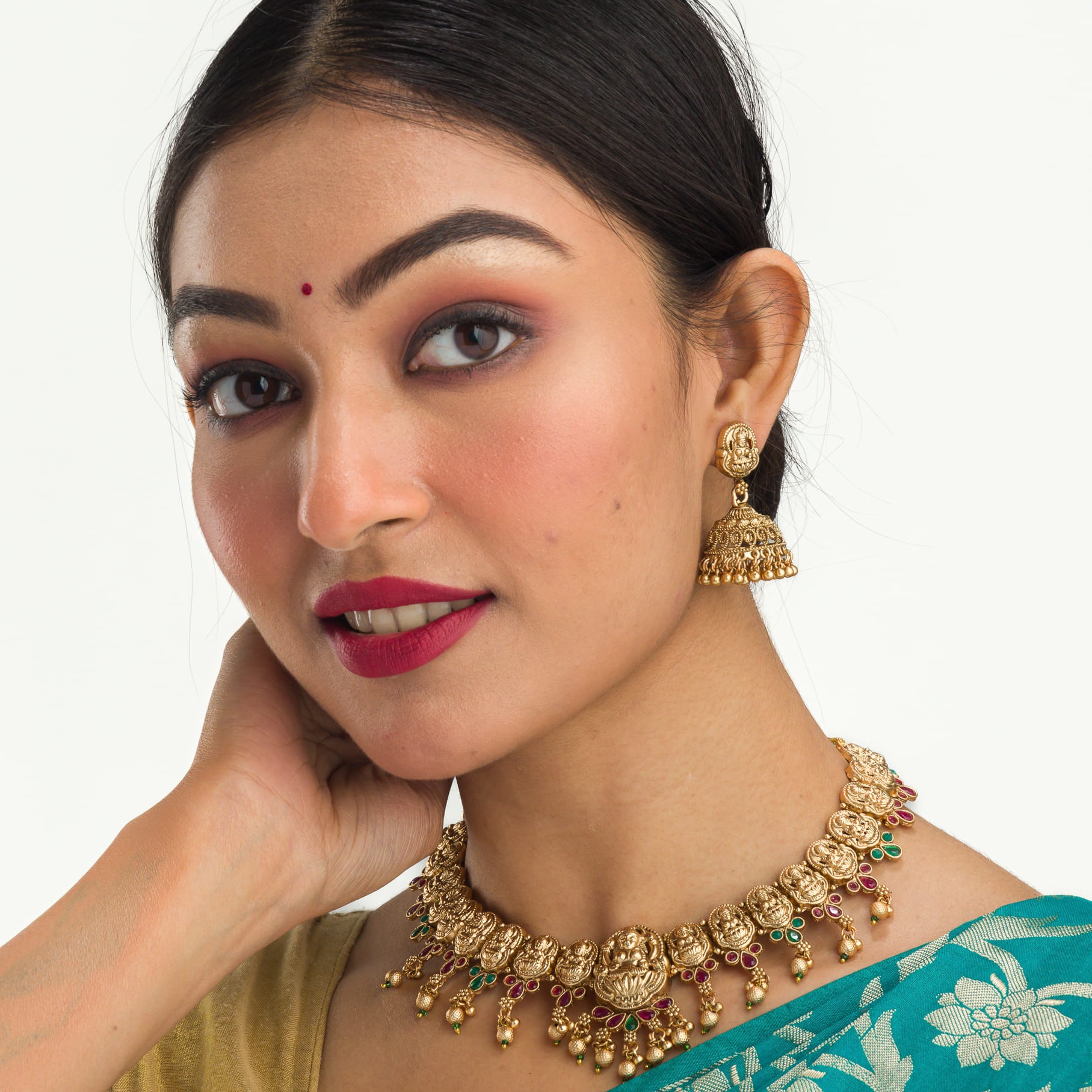 Gold-tone temple necklace set with golden beads offers timeless elegance