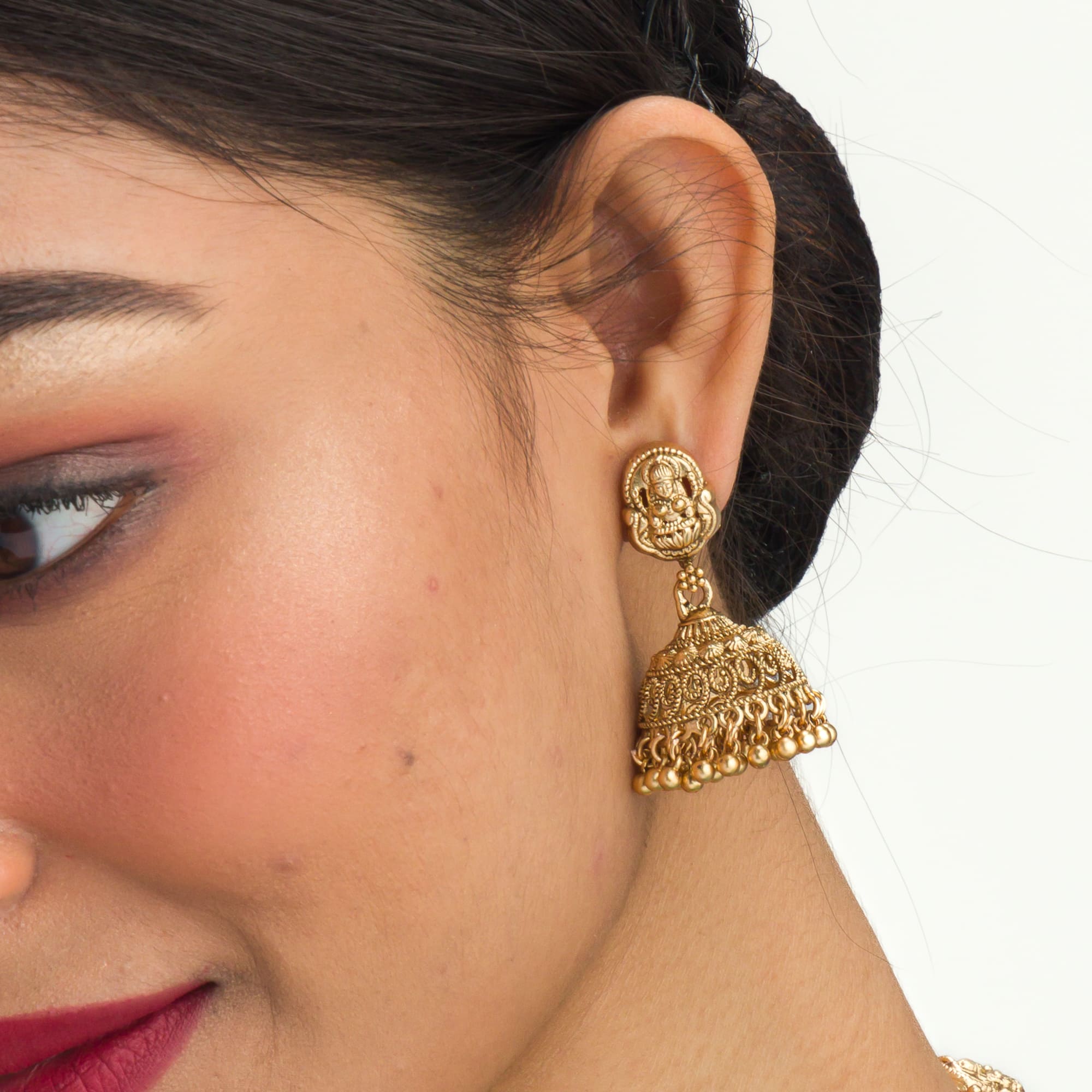 Gold-tone temple necklace set with golden beads offers timeless elegance