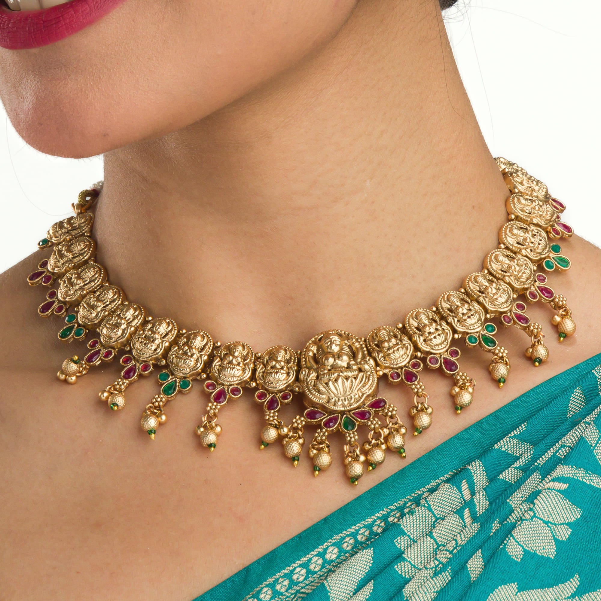 Gold-tone temple necklace set with golden beads offers timeless elegance