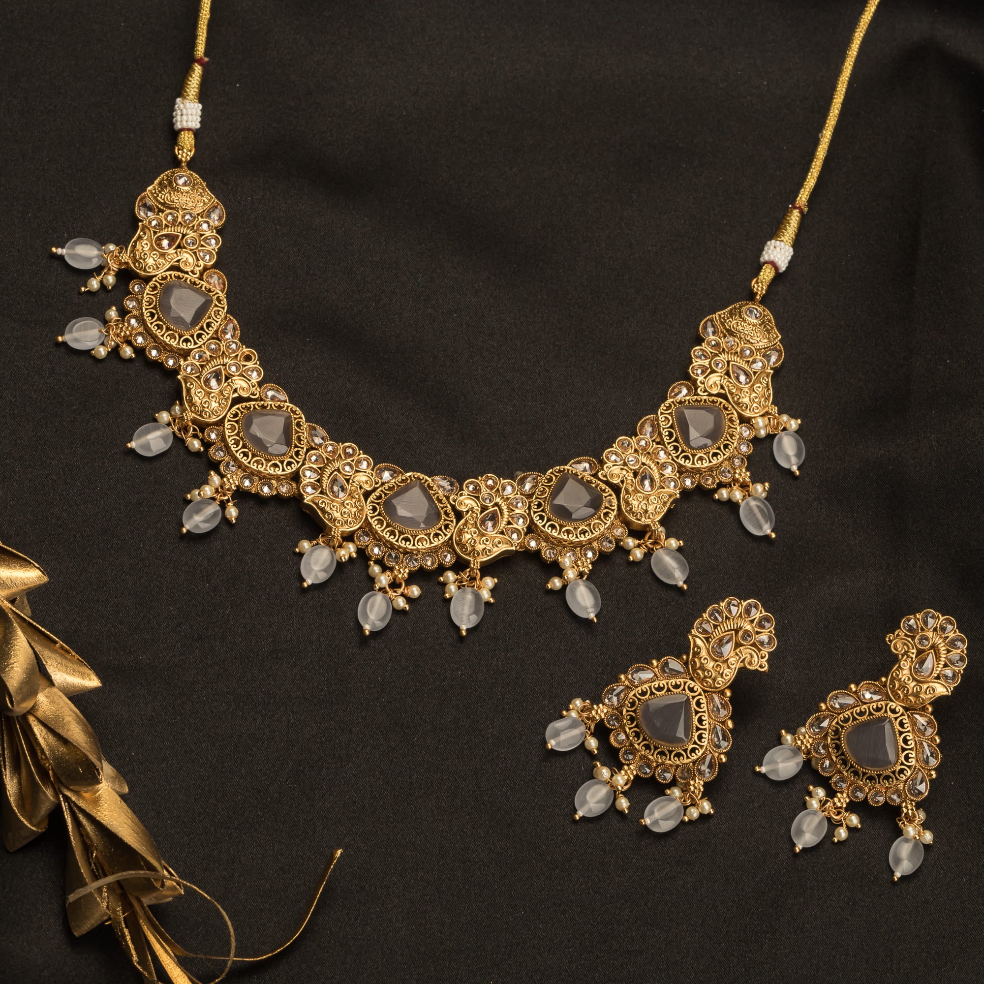 "Gold-tone necklace with grey stones and Kundan for a chic, modern appeal."