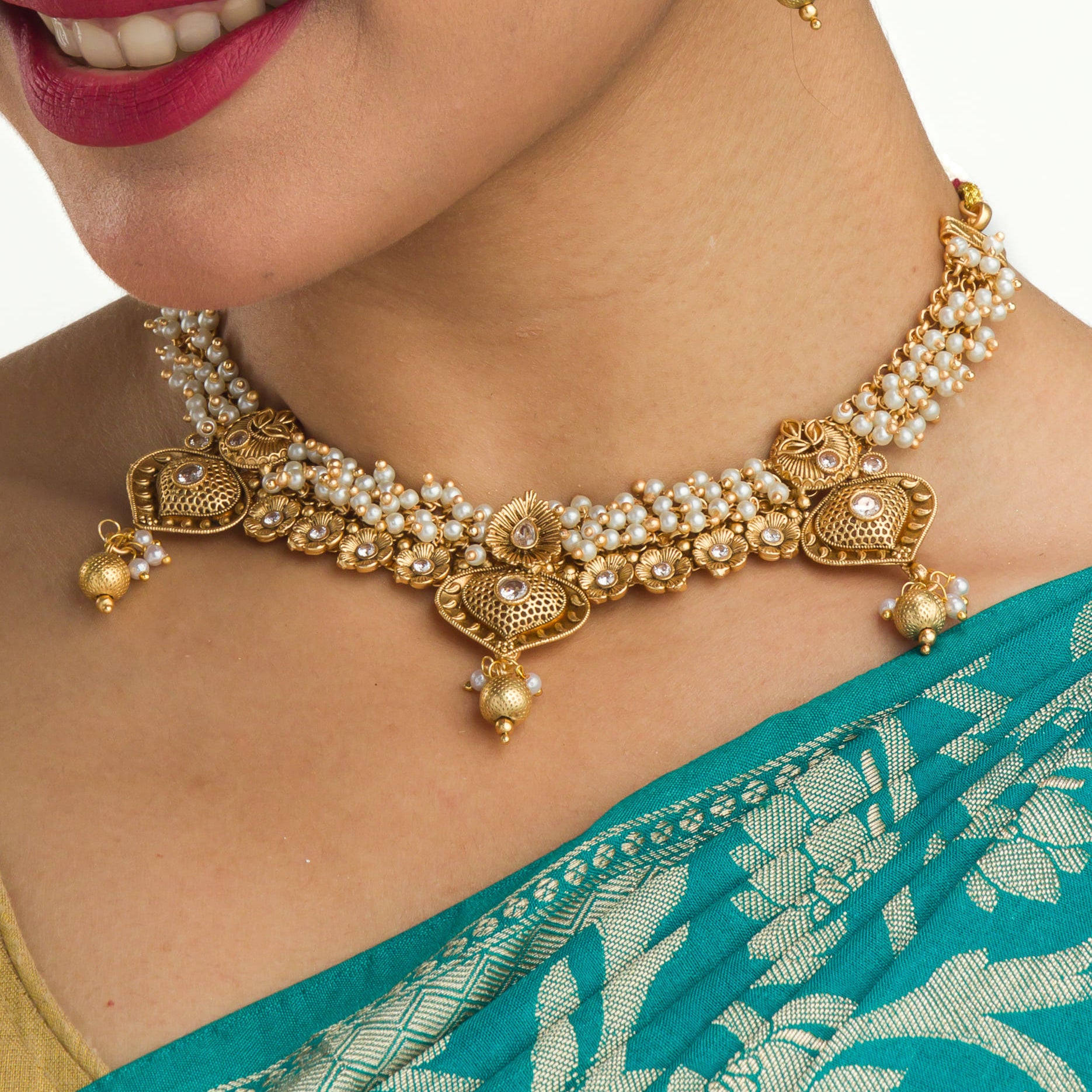 "Elegant goldtone necklace with lustrous pearls for timeless sophistication."