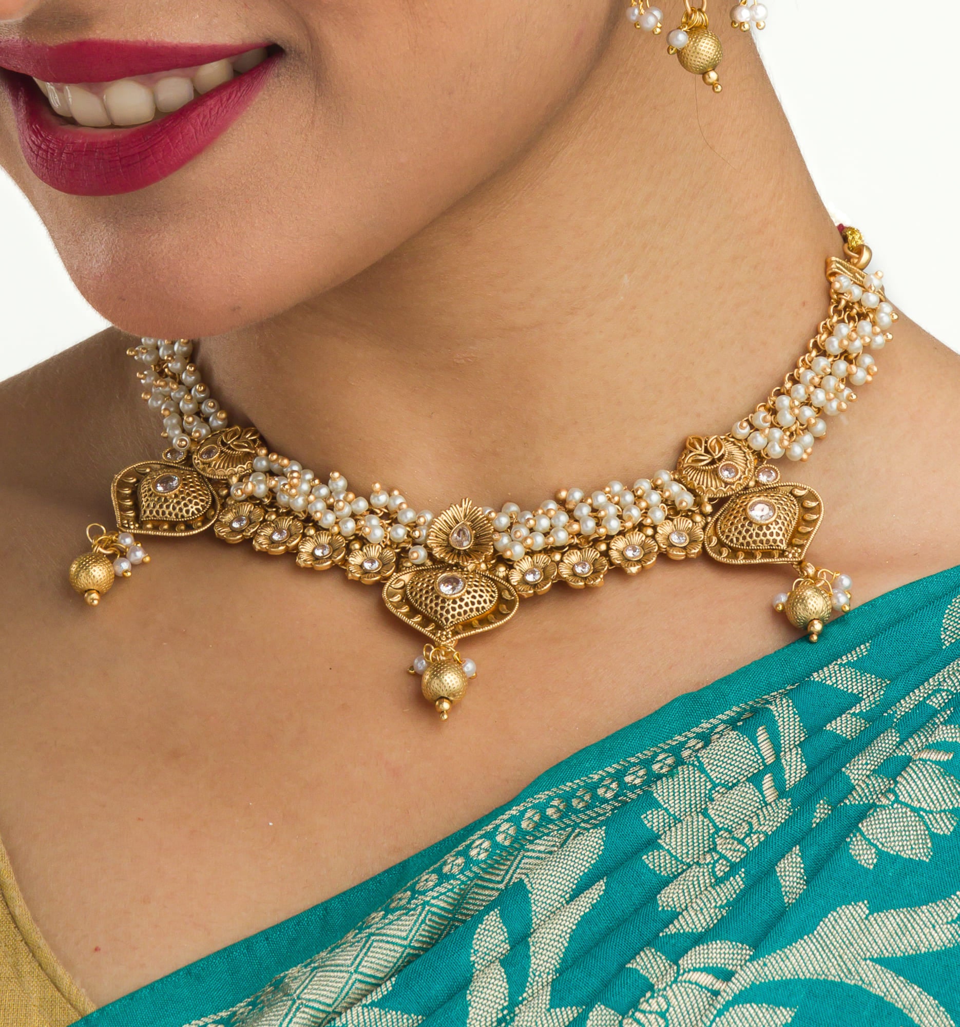 "Elegant goldtone necklace with lustrous pearls for timeless sophistication."
